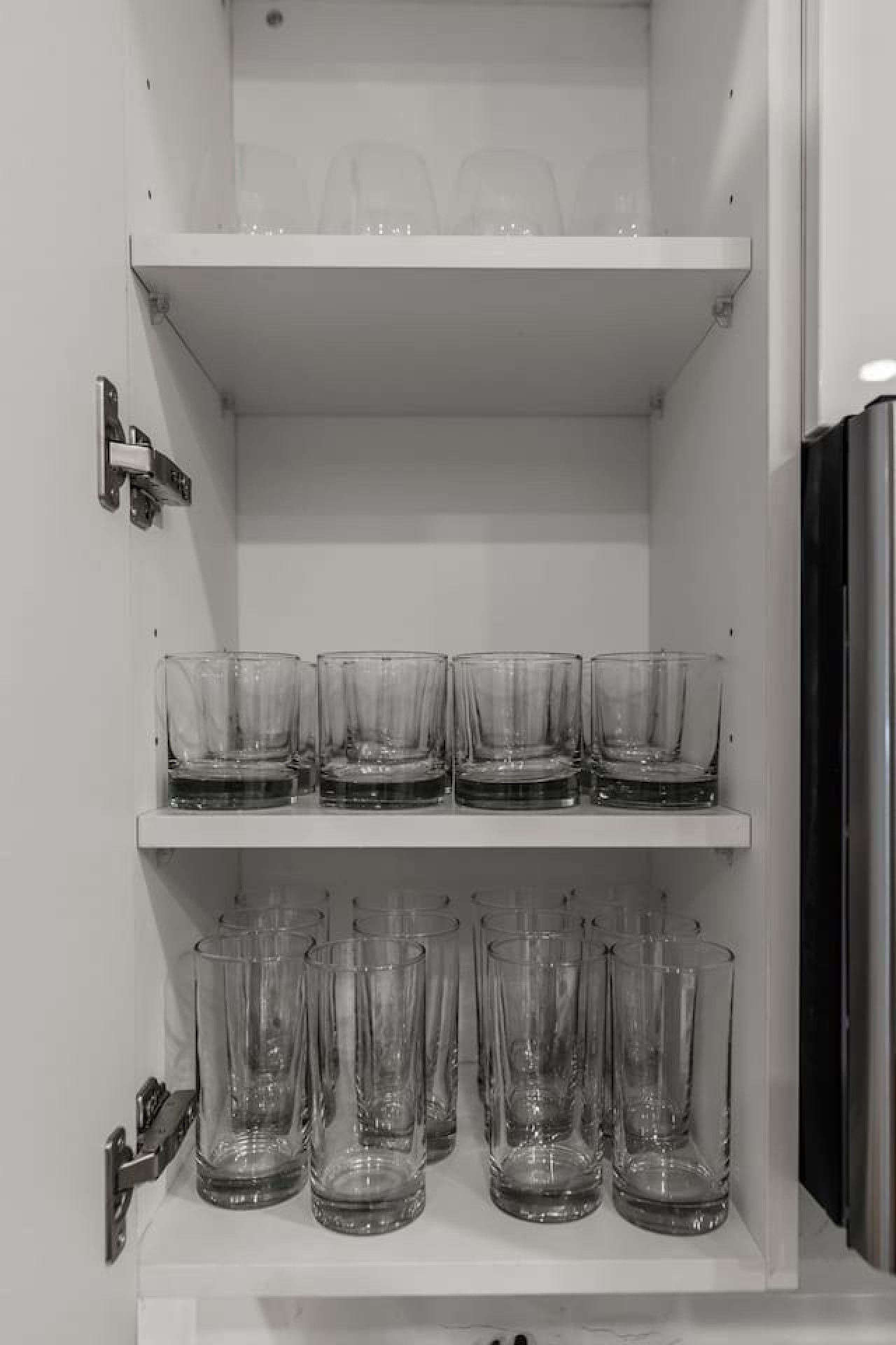 Kitchen cabinets stocked with cooking wares, glassware and silverwares, ideal for mixing up your favorite meals and drinks during your stay.