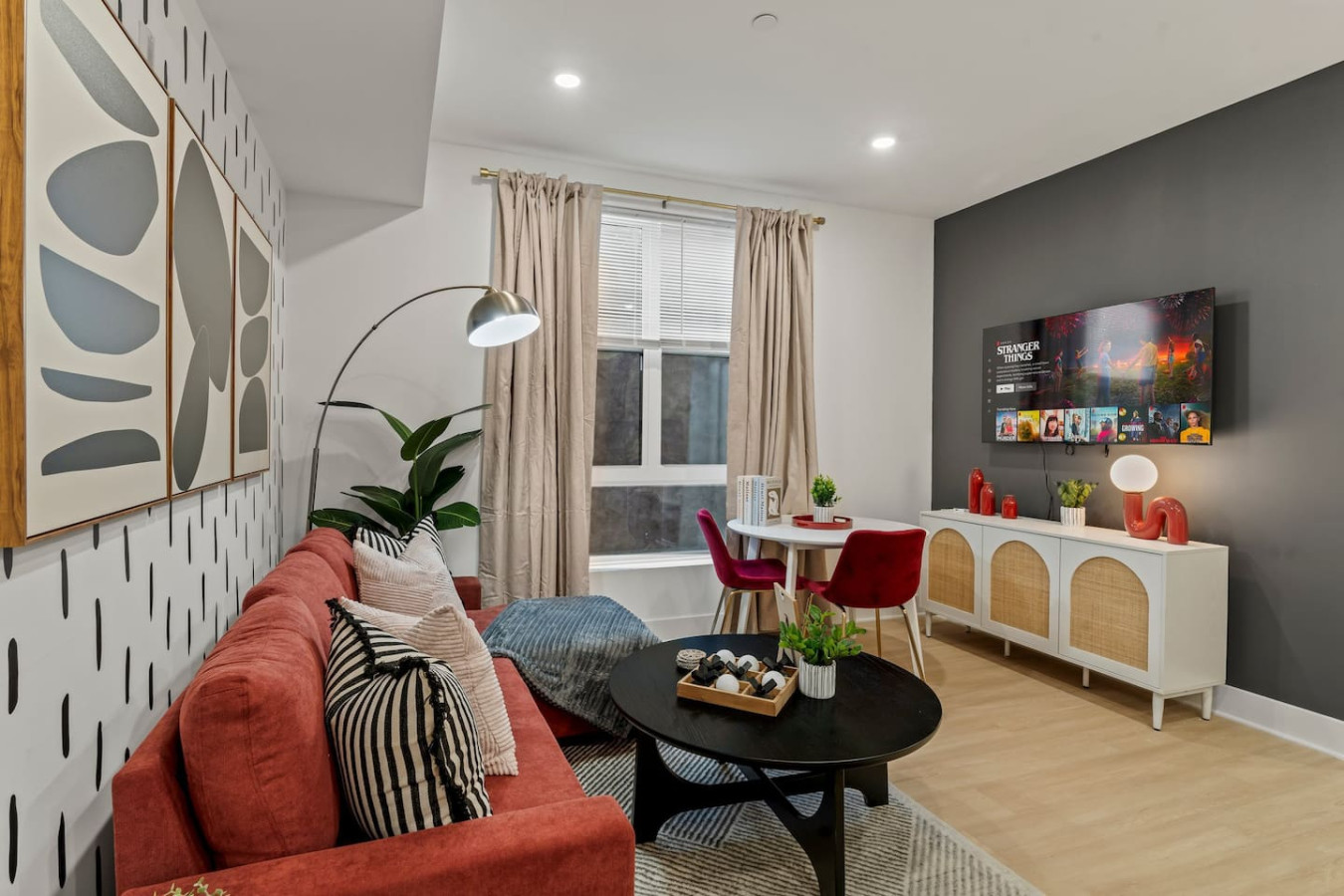 Living Room with Pull Out Sofa Bed, Coffee Table, Dining Table, 55" TV, Overhanging Reading Light