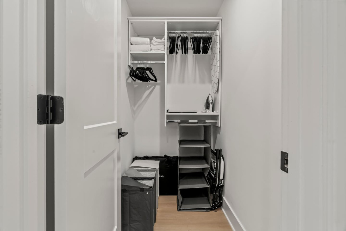 Walk-In Closet with Hangars, Extra Towels, and Clothing Storage.