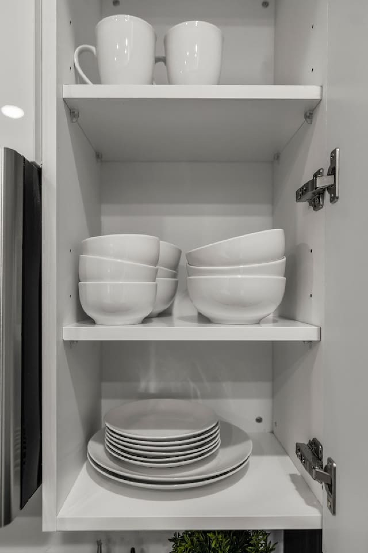 Kitchen cabinets stocked with cooking wares, glassware and silverwares, ideal for mixing up your favorite meals and drinks during your stay.