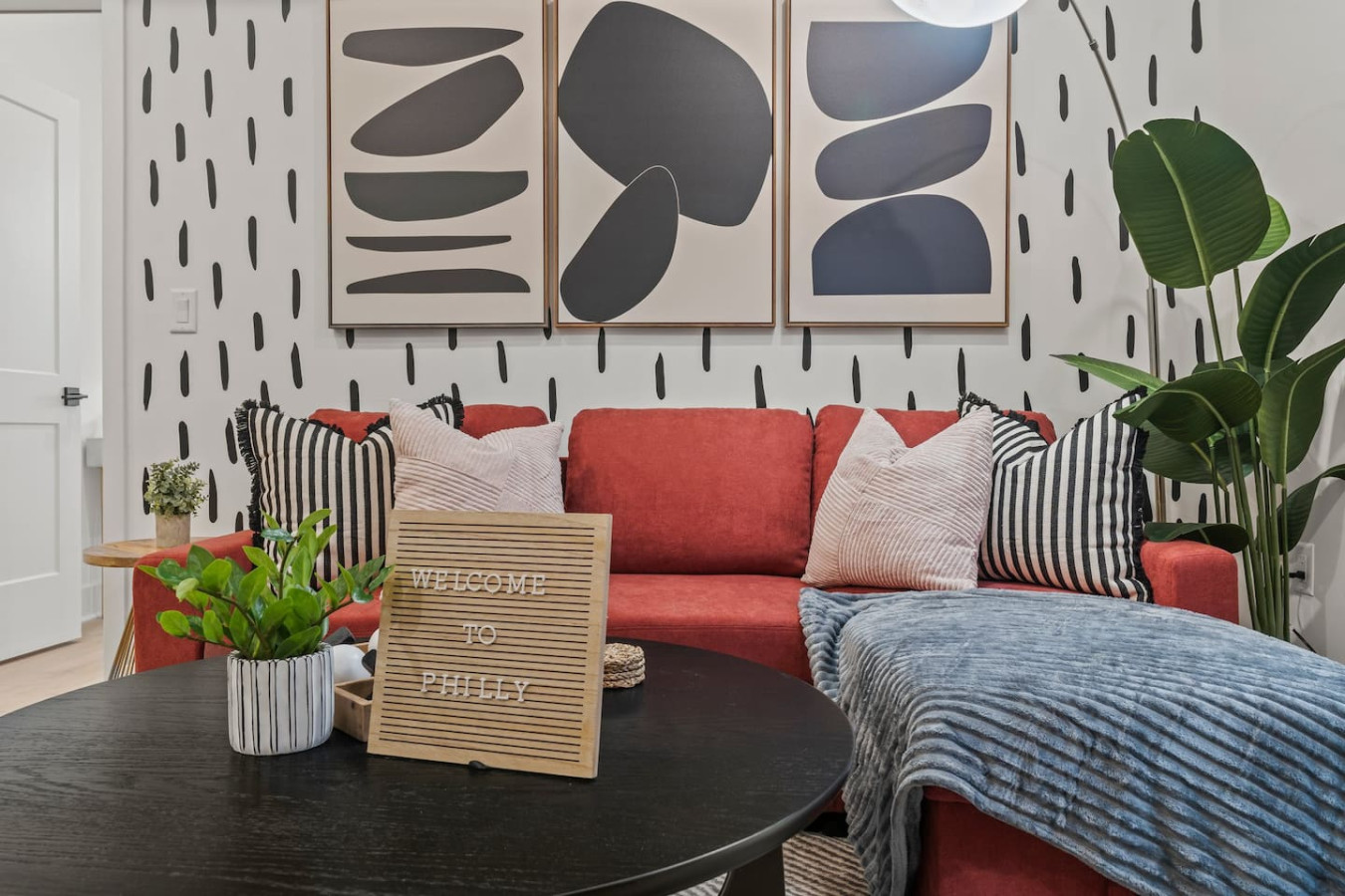 Living Room with Pull Out Sofa Bed, Coffee Table, Dining Table, 55" TV, Overhanging Reading Light