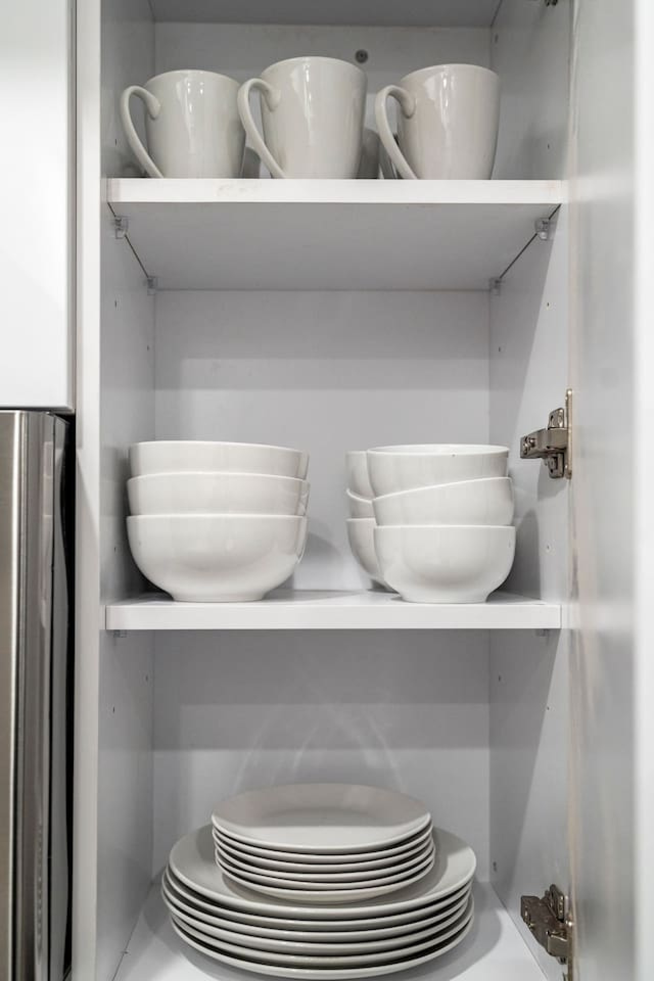Kitchen cabinets stocked with cooking wares, glassware and silverwares, ideal for mixing up your favorite meals and drinks during your stay.