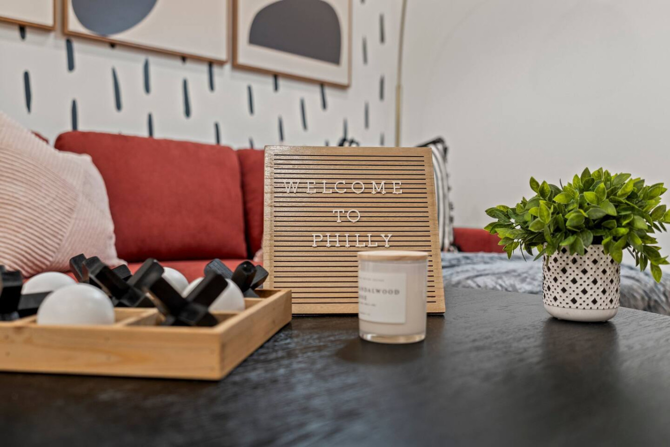 Homey vibes with cozy decor, a playful tic-tac-toe game, and a touch of greenery for a relaxing stay.
