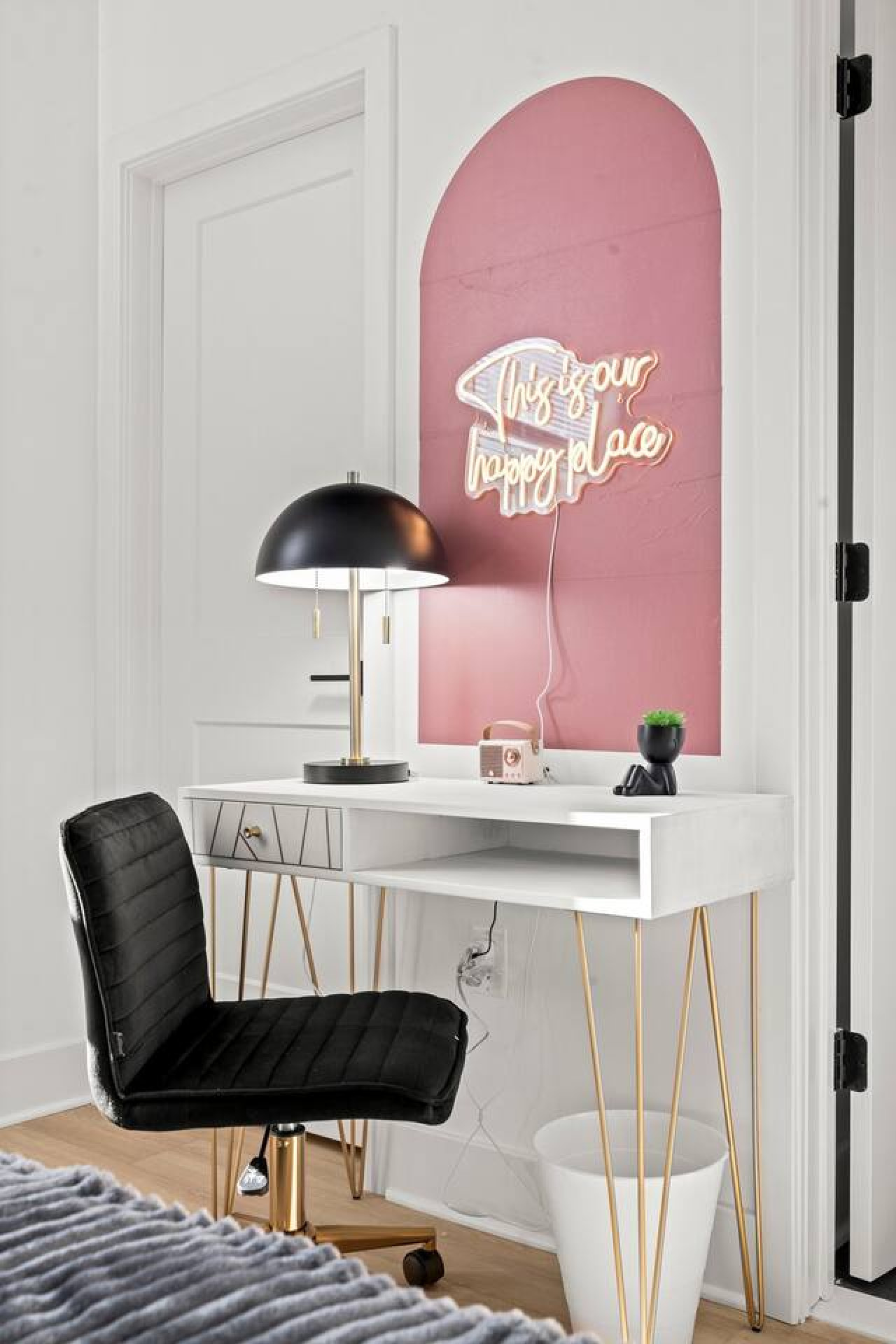 Dedicated workspace with table, chair, and lamp.