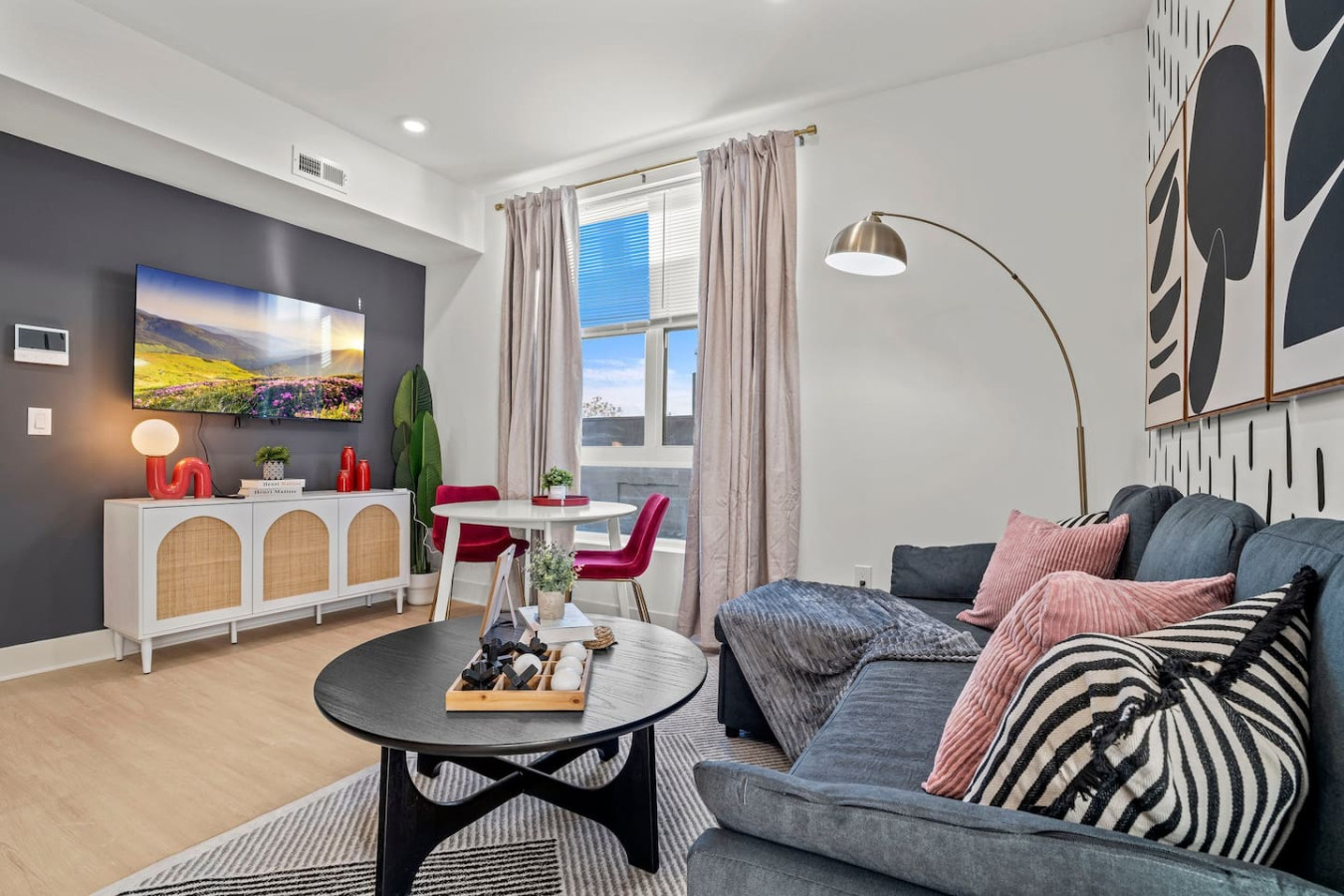 55" Smart TV with beautiful plant, decoration, and a sofa bed in the living room