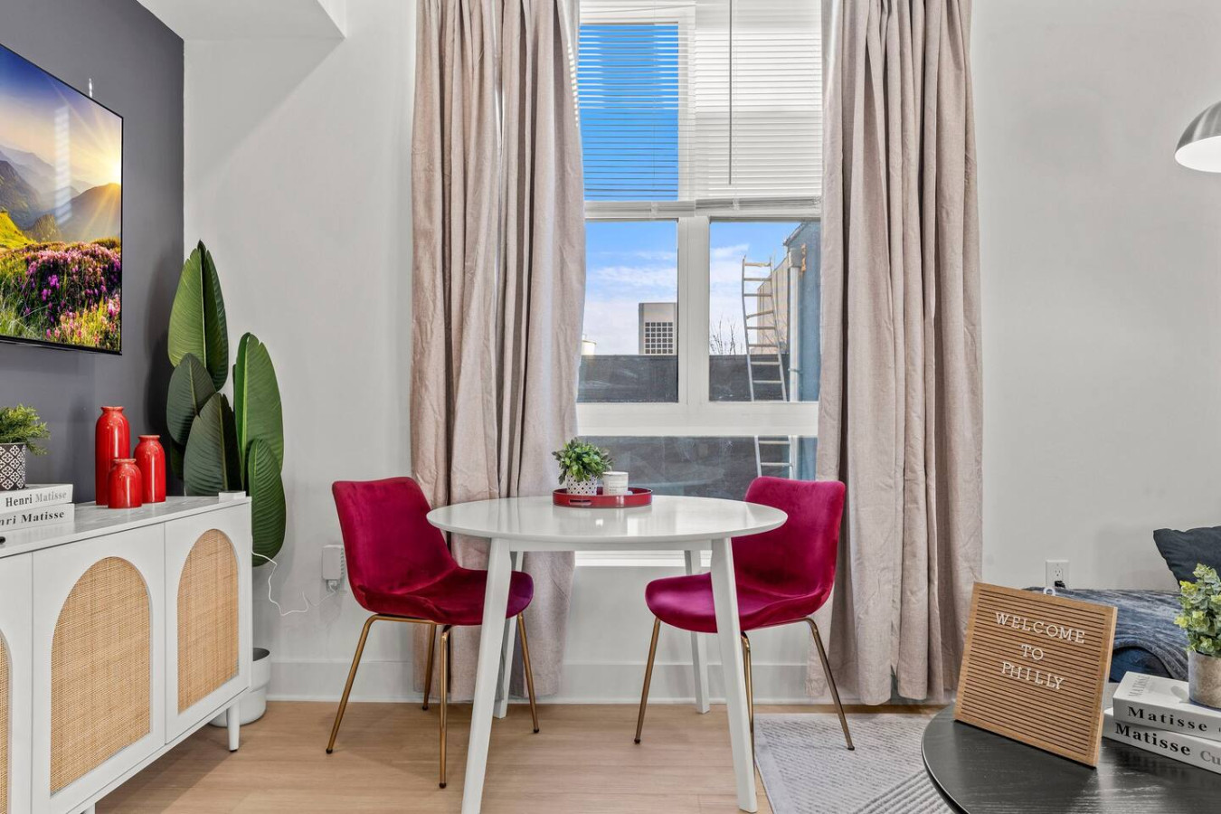 Compact dining table with accent chairs and decorative plants