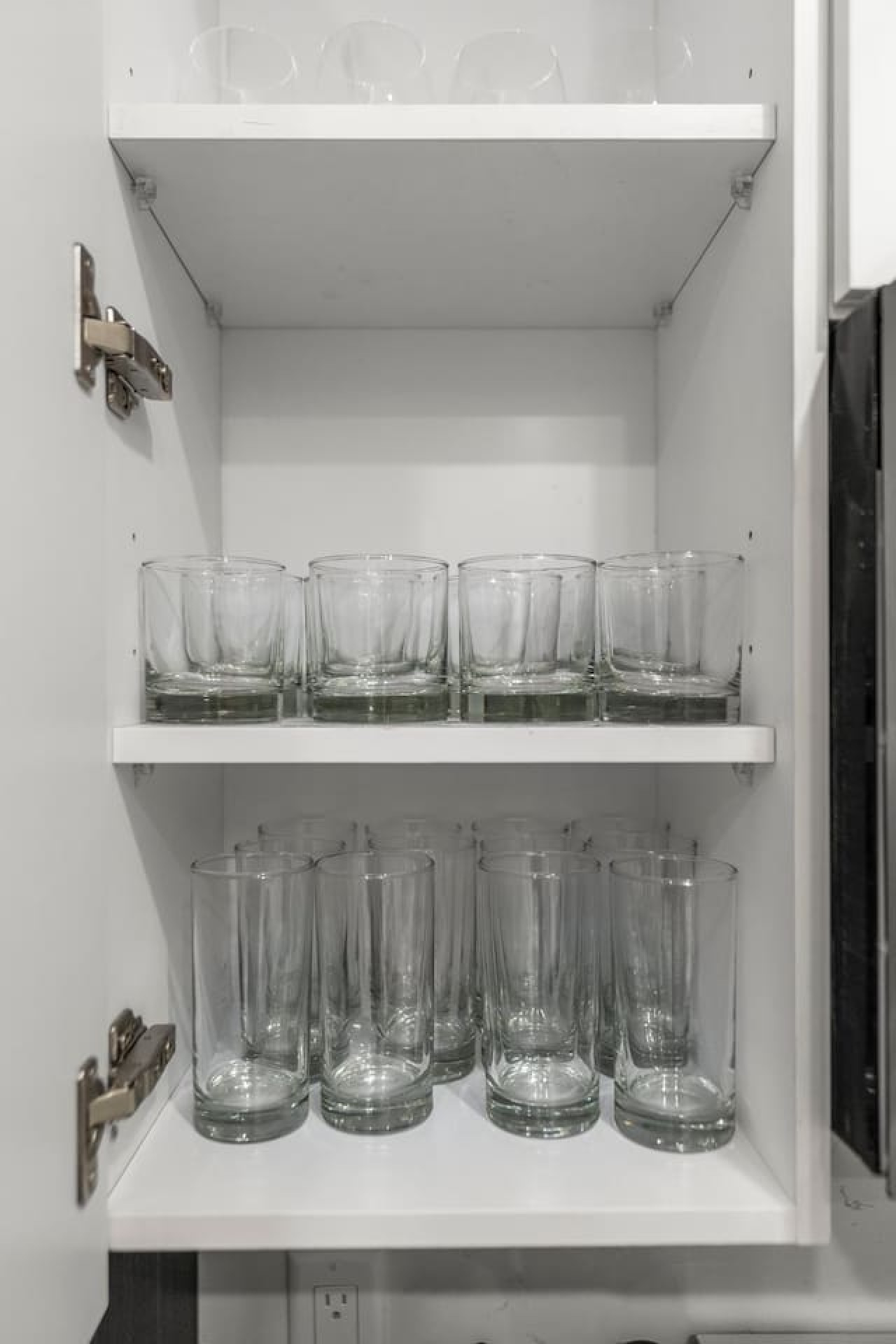 Kitchen cabinets stocked with cooking wares, glassware and silverwares, ideal for mixing up your favorite meals and drinks during your stay.