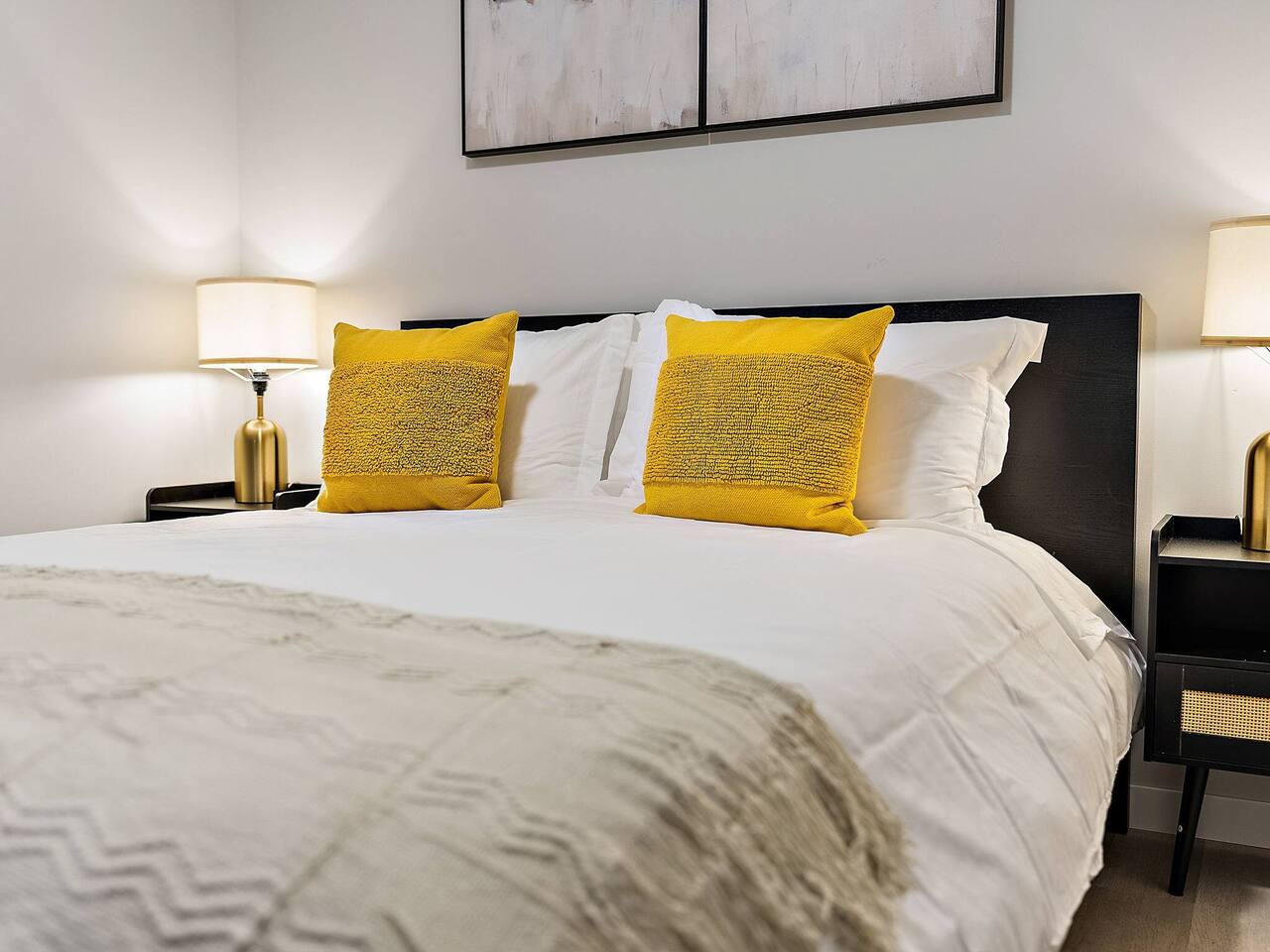 You feel enveloped in comfort as you relax on the queen bed, surrounded by a room designed for tranquility.