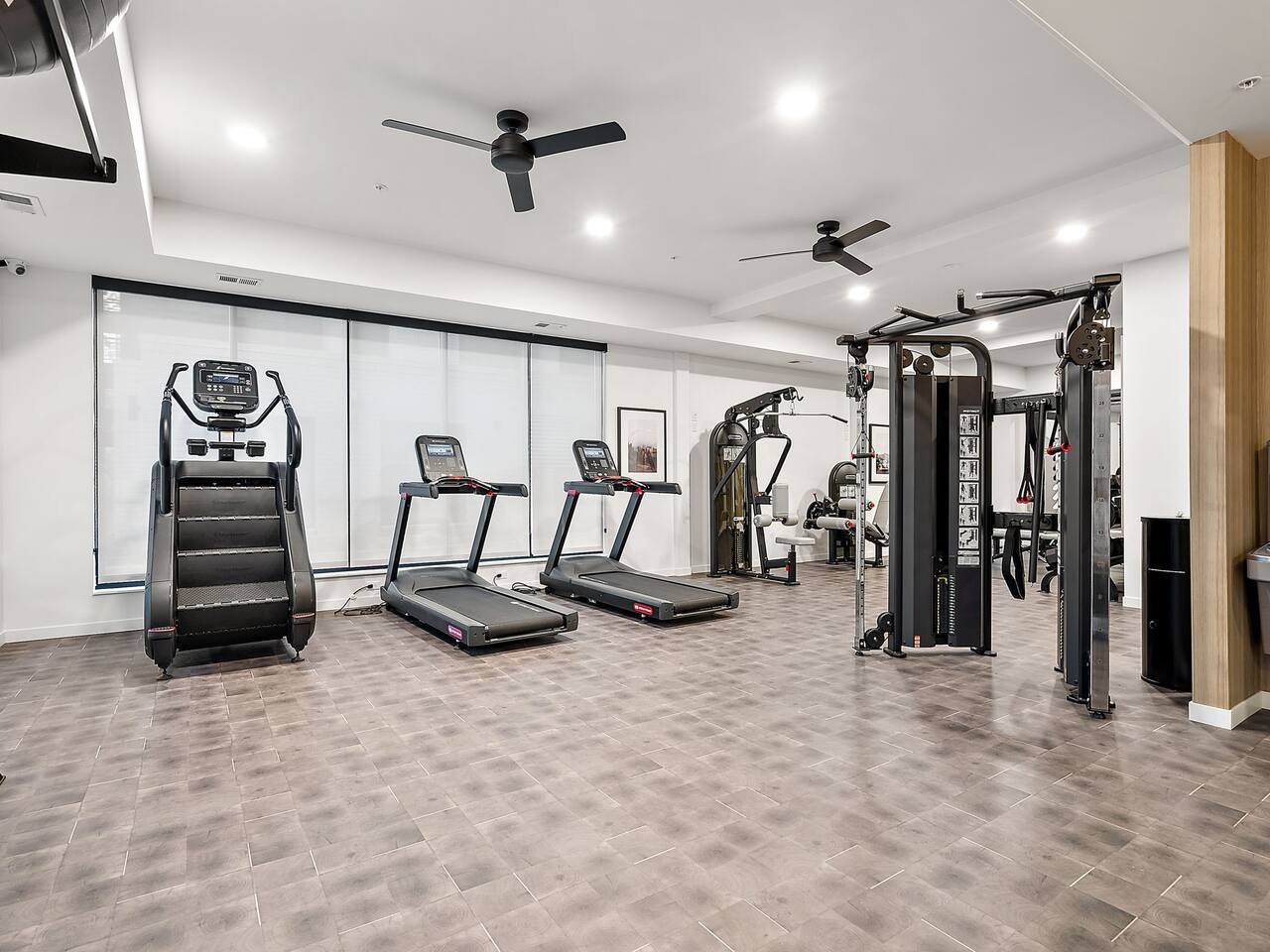 Open floor area with exercise mats, yoga balls, and foam rollers for warm-ups, stretching, or core exercises.