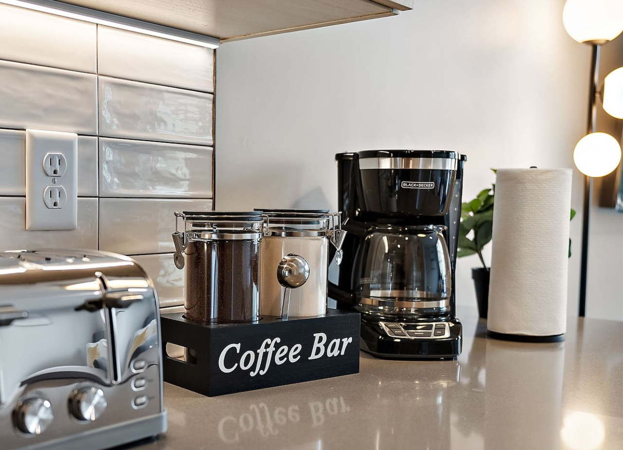 As you open the kitchen, you discover an assortment of coffee pods, and sugar, ensuring you have everything you need for a perfect morning or afternoon pick-me-up.