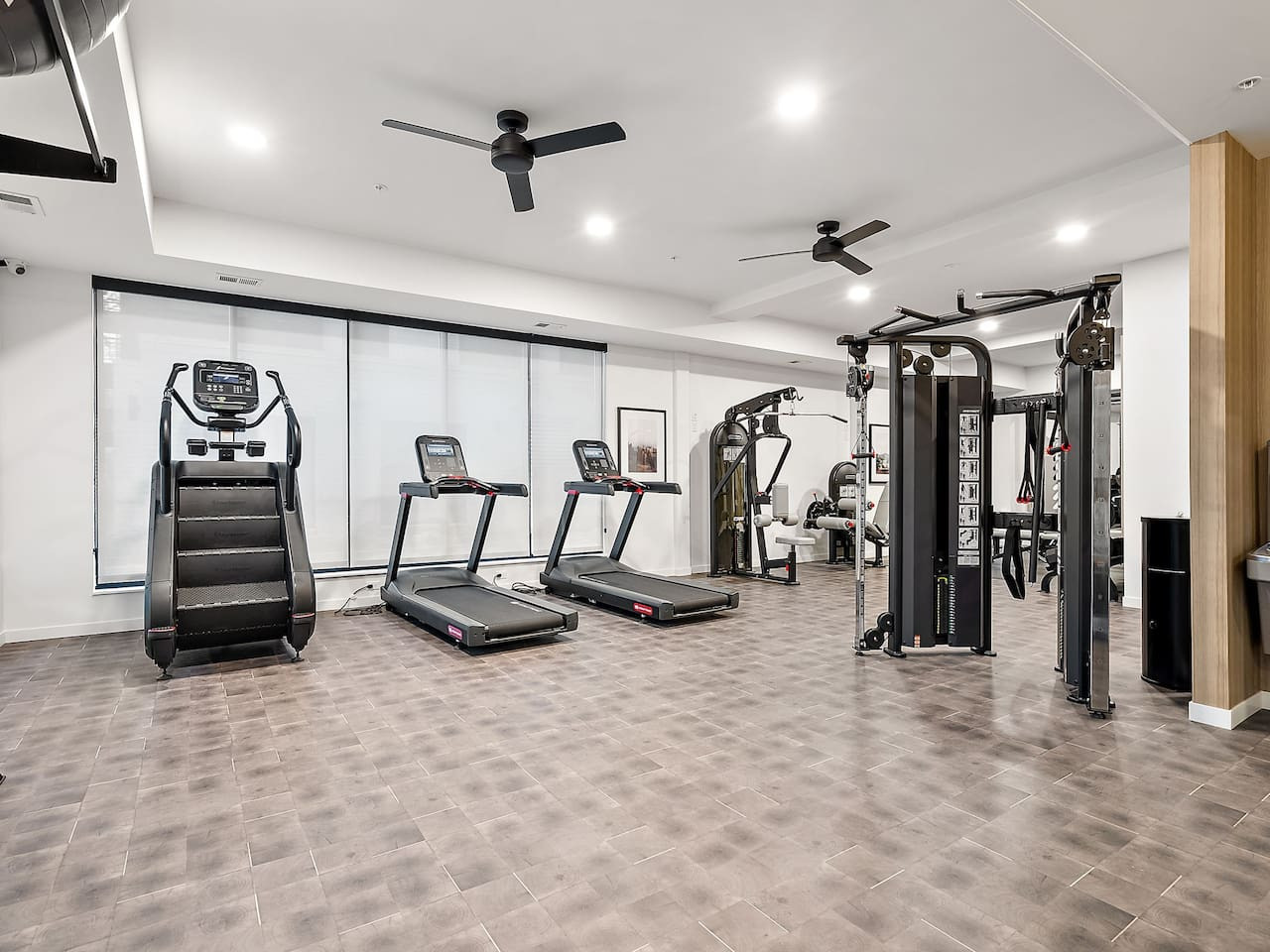 Open floor area with exercise mats, yoga balls, and foam rollers for warm-ups, stretching, or core exercises.