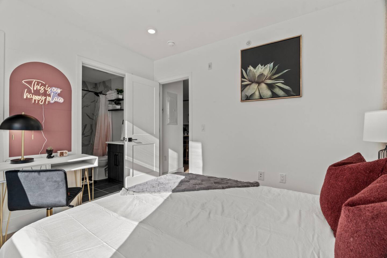 You feel enveloped in comfort as you relax on the queen bed, surrounded by a room designed for tranquility.