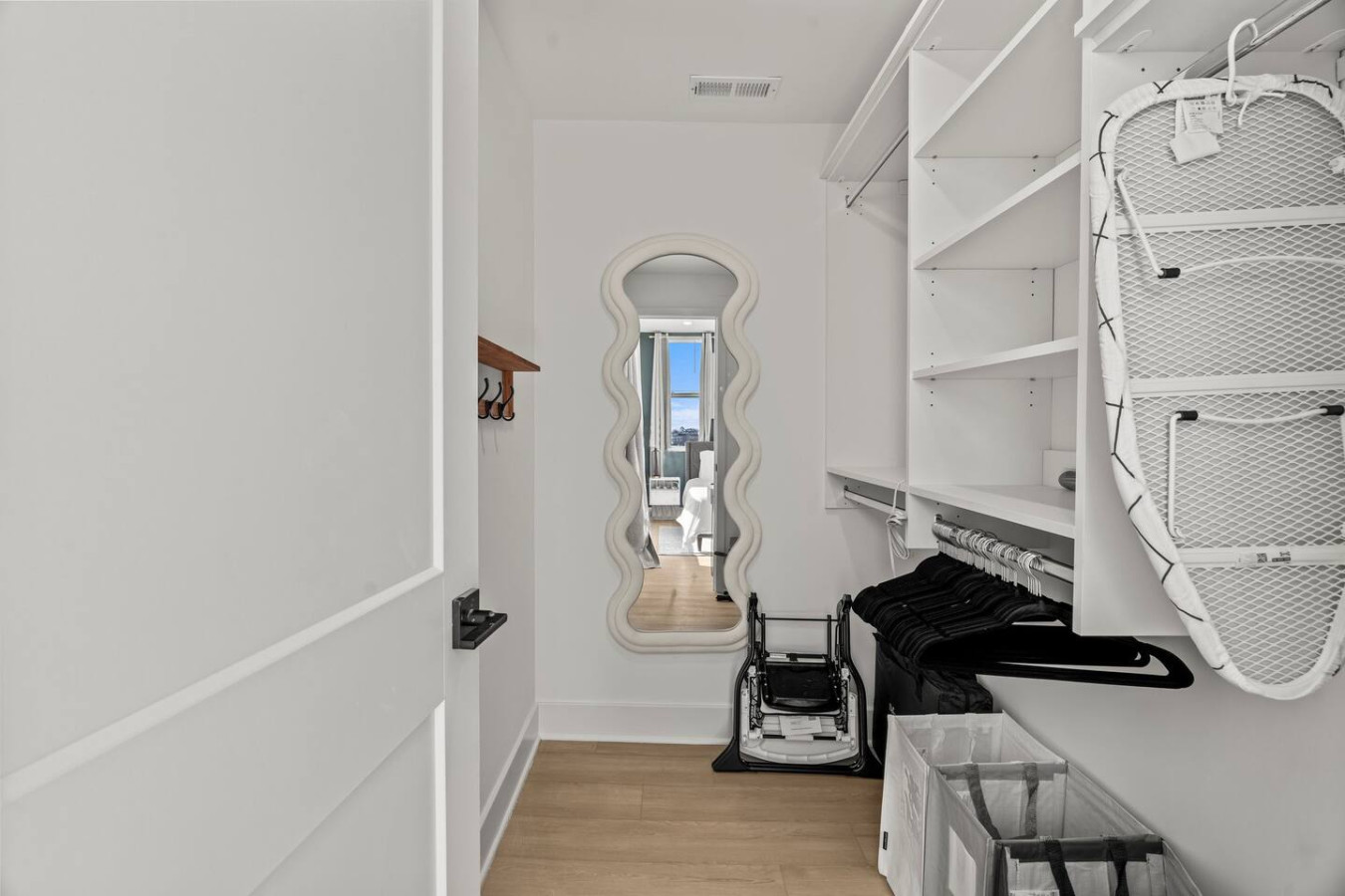 Sleek closet doors hide plenty of storage space, ensuring your room remains open and tidy during your stay.