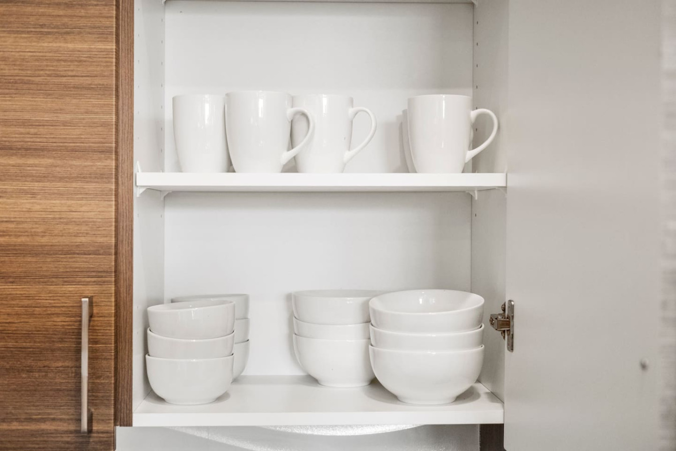Kitchen cabinets stocked with cooking wares, glassware and silverwares, ideal for mixing up your favorite meals and drinks during your stay.