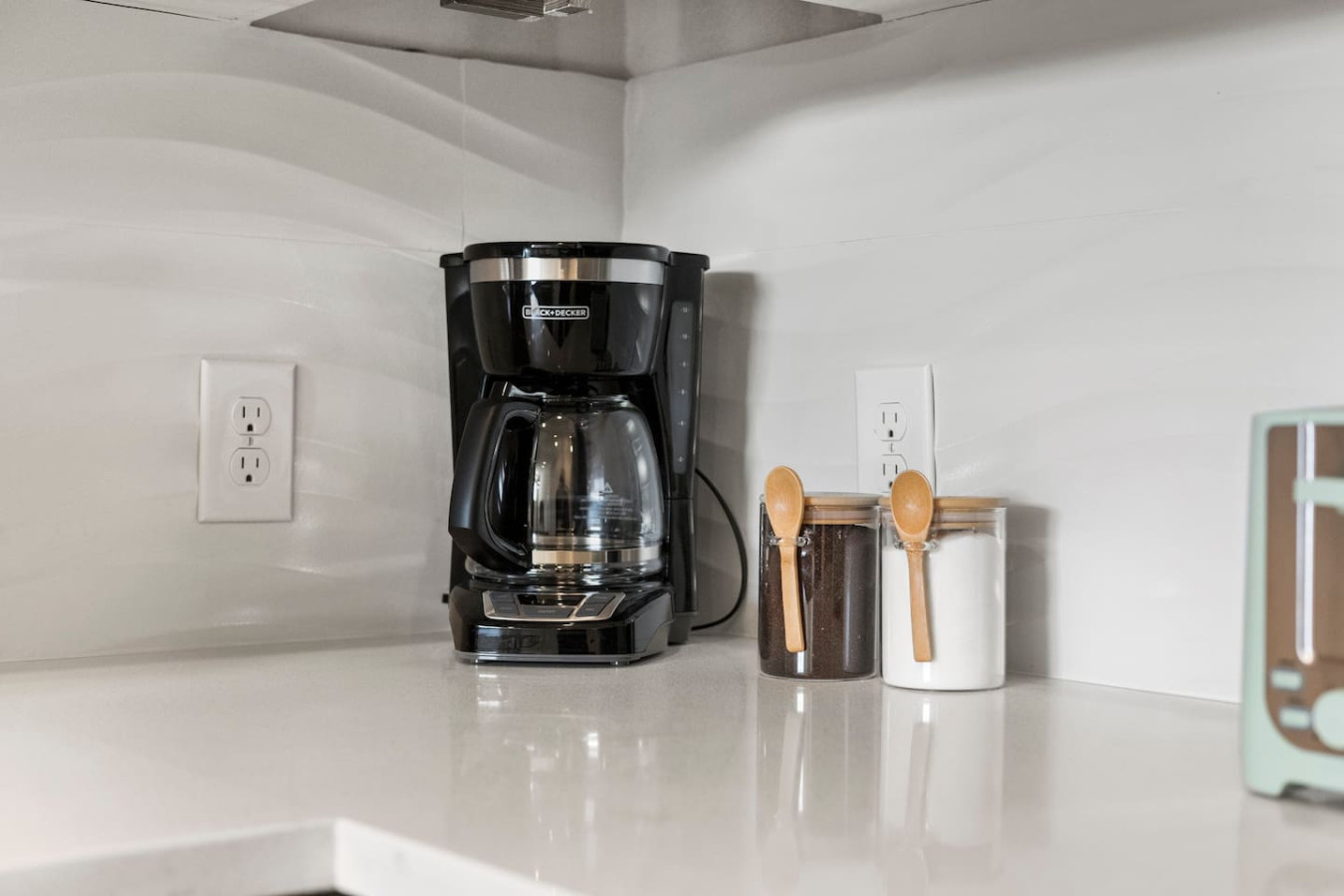As you open the kitchen, you discover an assortment of coffee pods, and sugar, ensuring you have everything you need for a perfect morning or afternoon pick-me-up.
