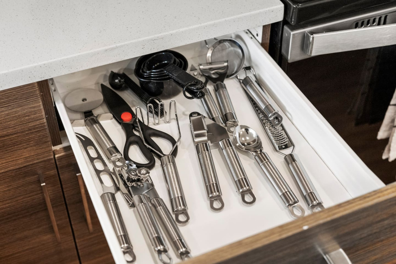 Kitchen utensils with scissors, measuring cups, grater, wine opener, can opener