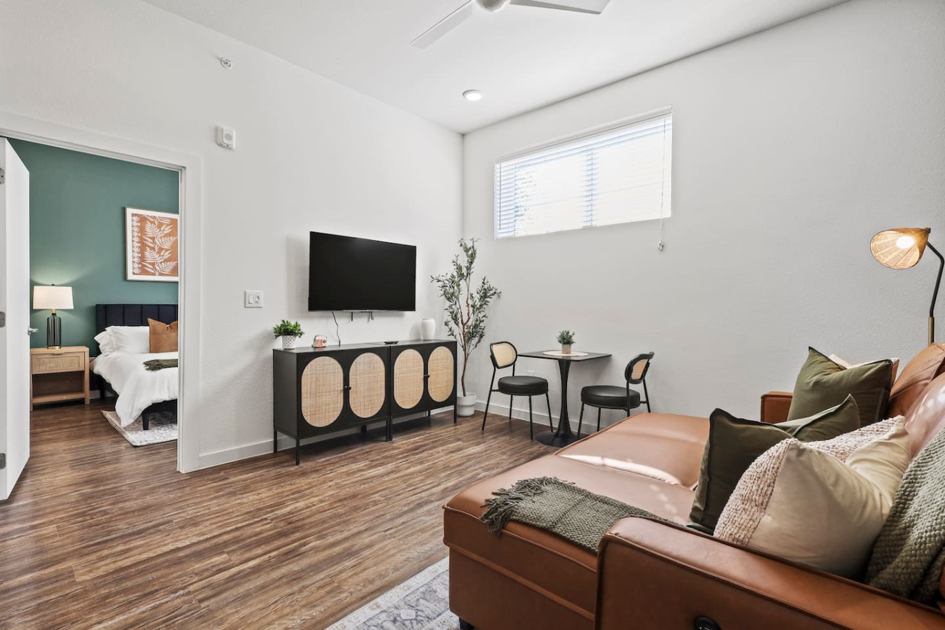 Bright and airy living room with plush seating, a large TV, and tasteful decor, creating the perfect space for relaxation and entertainment.