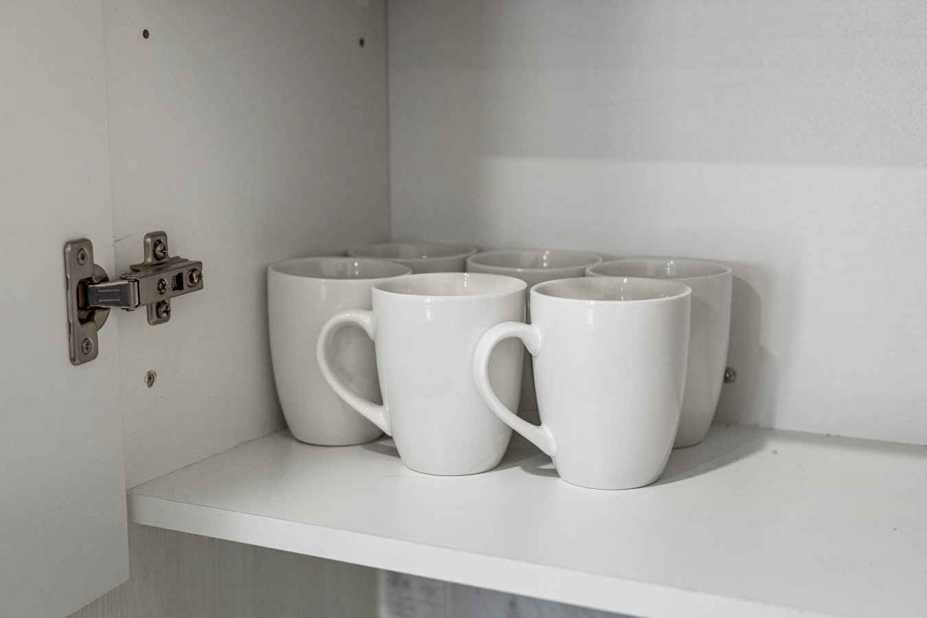 Start your day with a fresh cup—mugs ready and waiting in our organized kitchen.