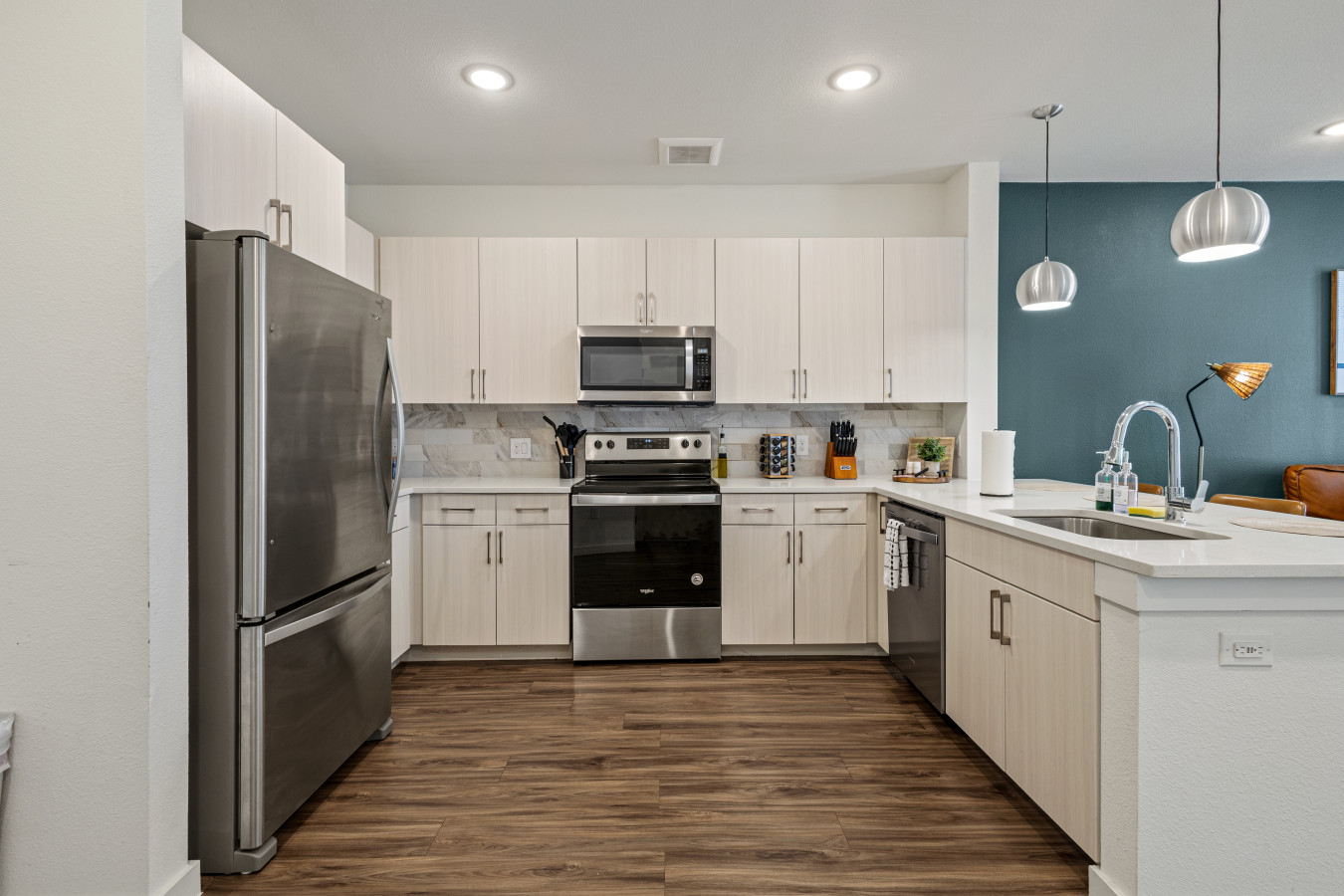Sleek kitchen featuring stainless steel appliances, ample storage, and stylish lighting for a comfortable cooking experience.