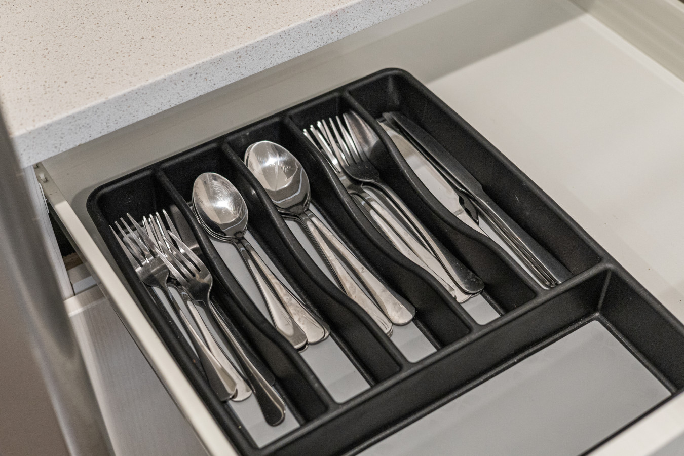 Thoughtfully organized kitchen utensils for your convenience.