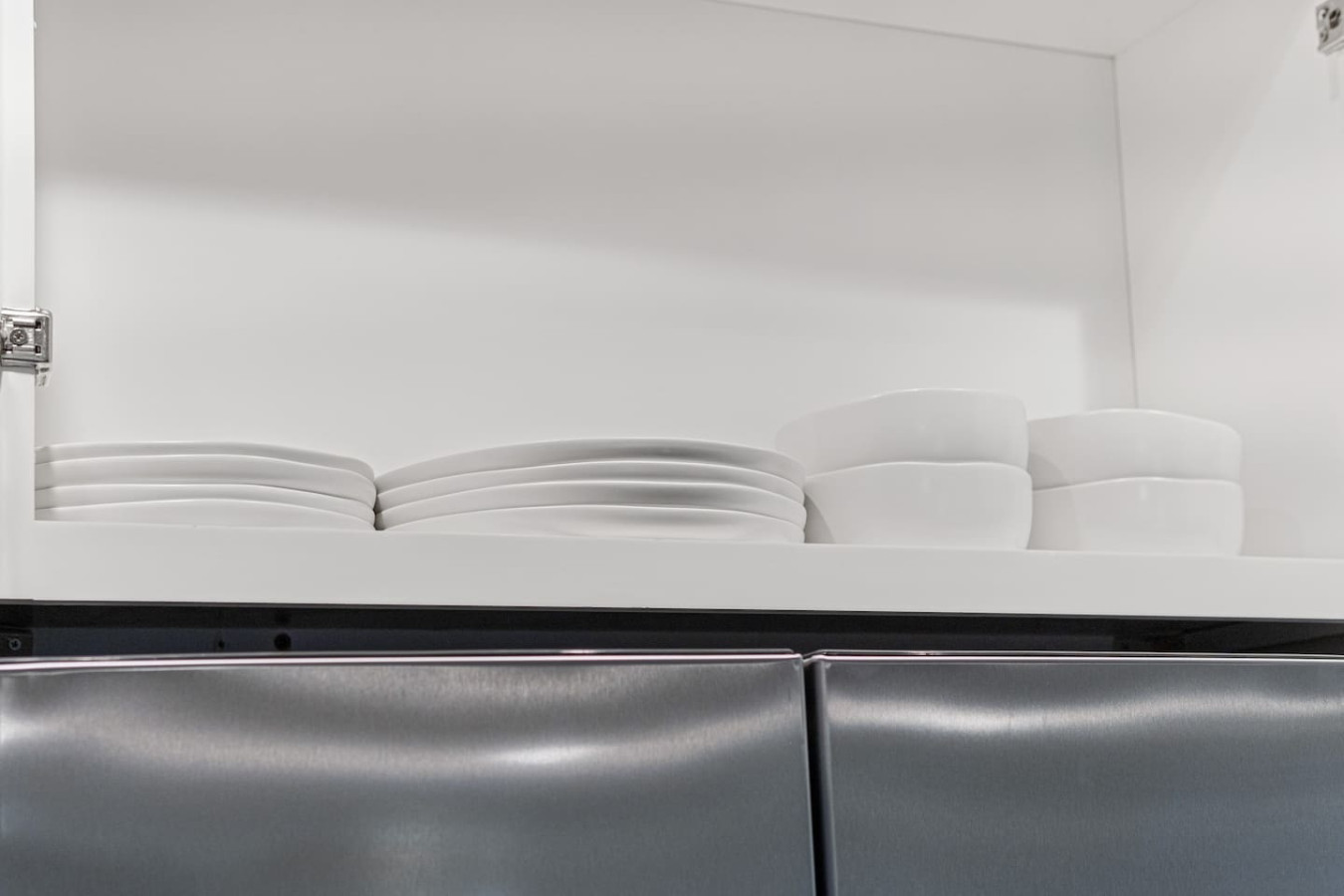 Kitchen cabinets stocked with cooking wares, glassware and silverwares, ideal for mixing up your favorite meals and drinks during your stay.
