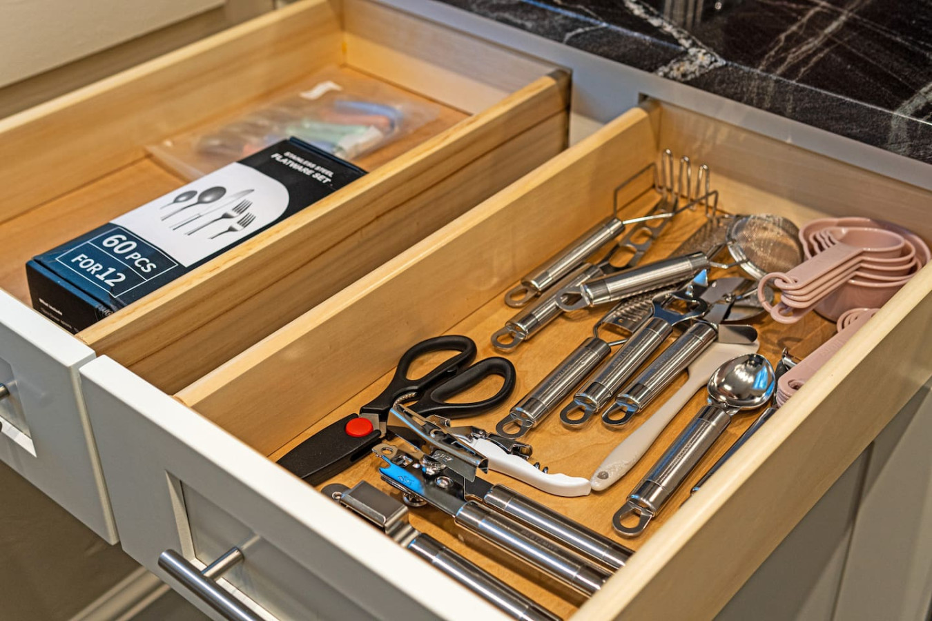 Kitchen cabinets stocked with cooking wares, glassware and silverwares, ideal for mixing up your favorite meals and drinks during your stay.