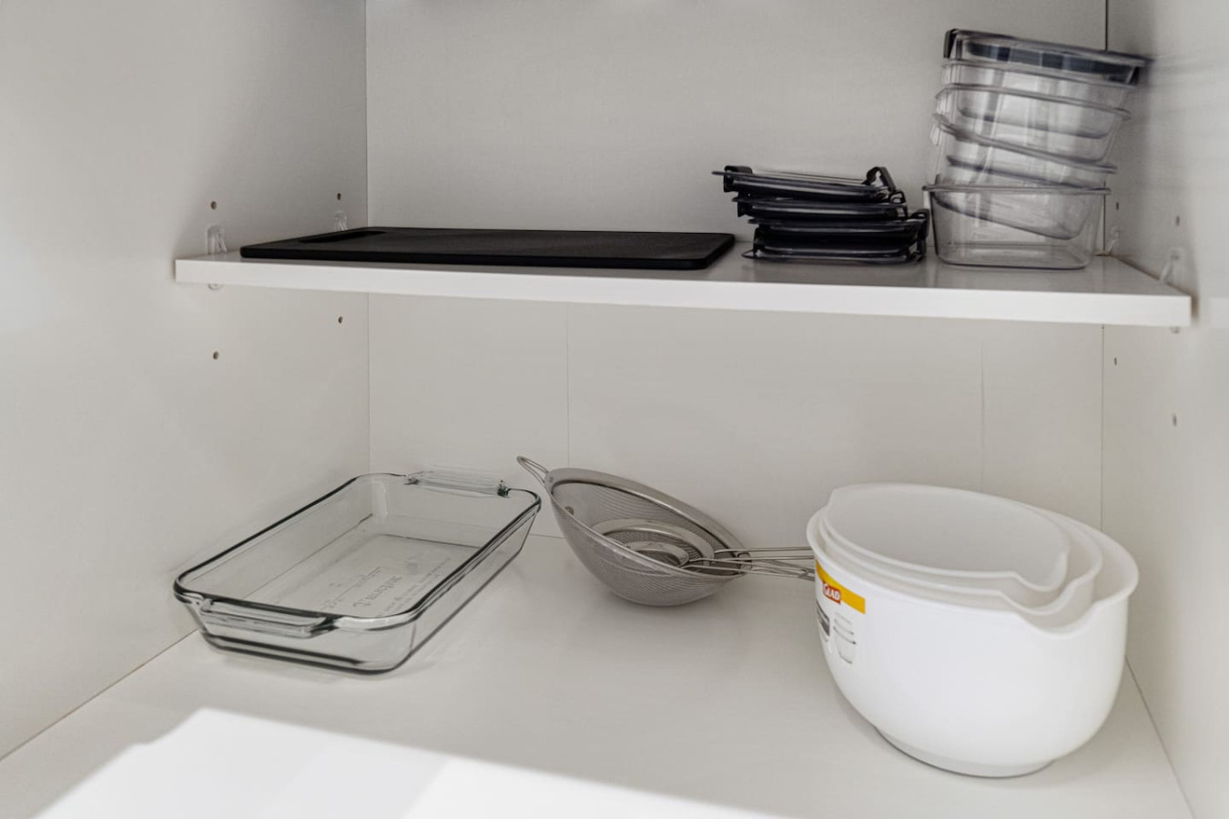 Kitchen cabinets stocked with cooking wares, glassware and silverwares, ideal for mixing up your favorite meals and drinks during your stay.