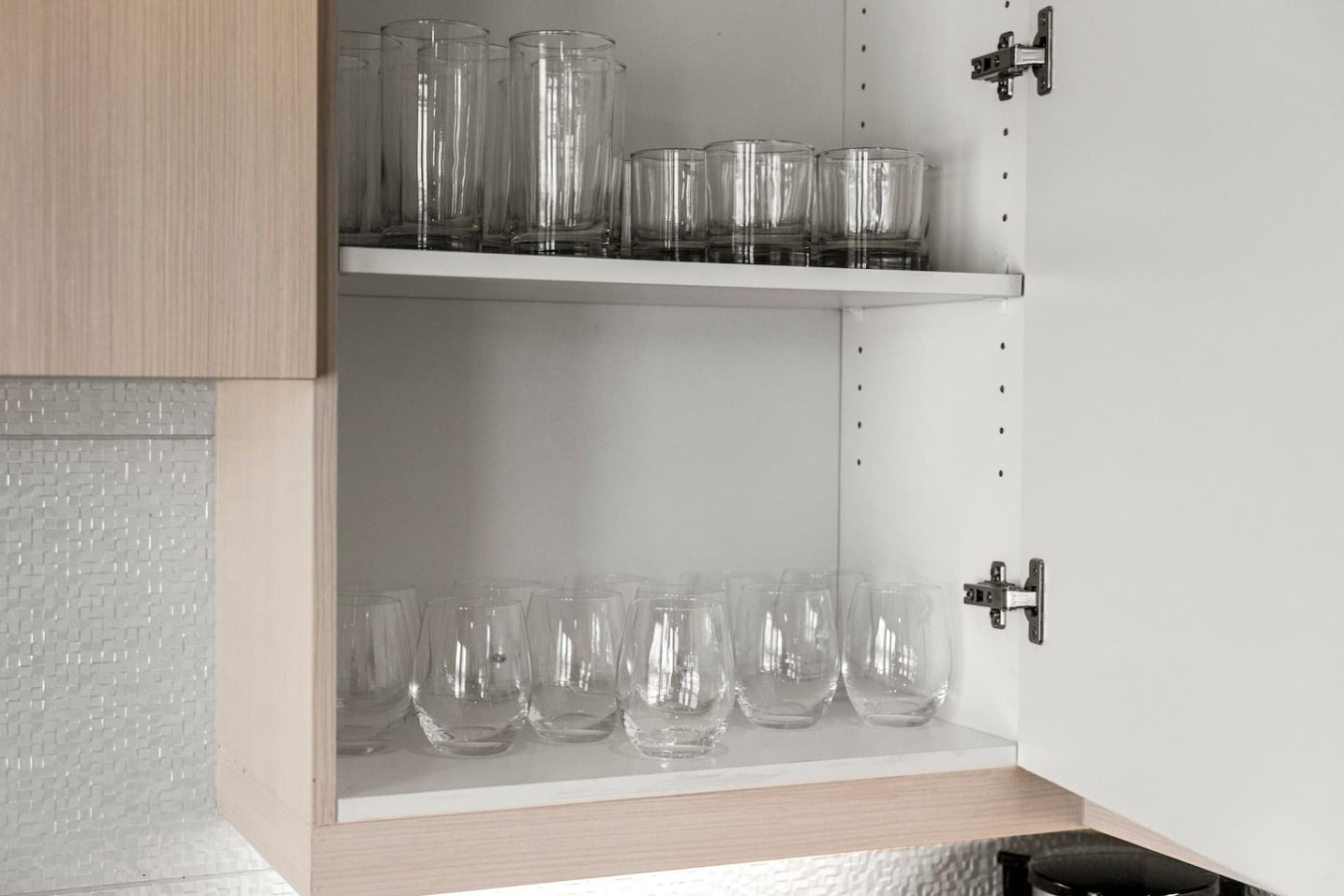 Kitchen cabinets stocked with cooking wares, glassware and silverwares, ideal for mixing up your favorite meals and drinks during your stay.