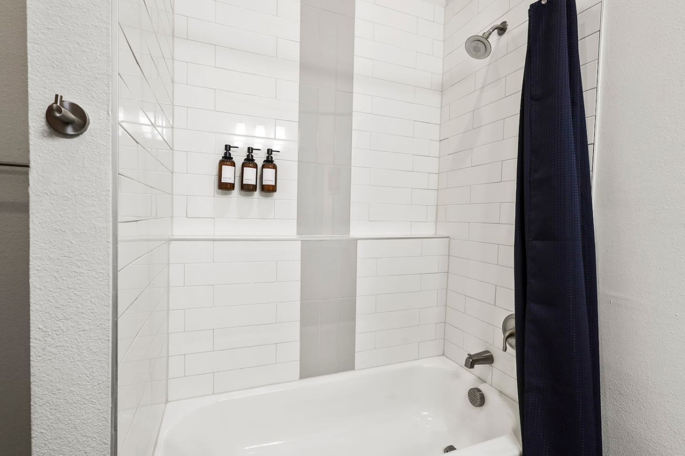 This bright and welcoming bathroom invites you to freshen up in comfort. Enjoy the forest-inspired shower curtain that adds a calming touch to your routine, complemented by the cozy rug underfoot and sparkling clean fixtures.