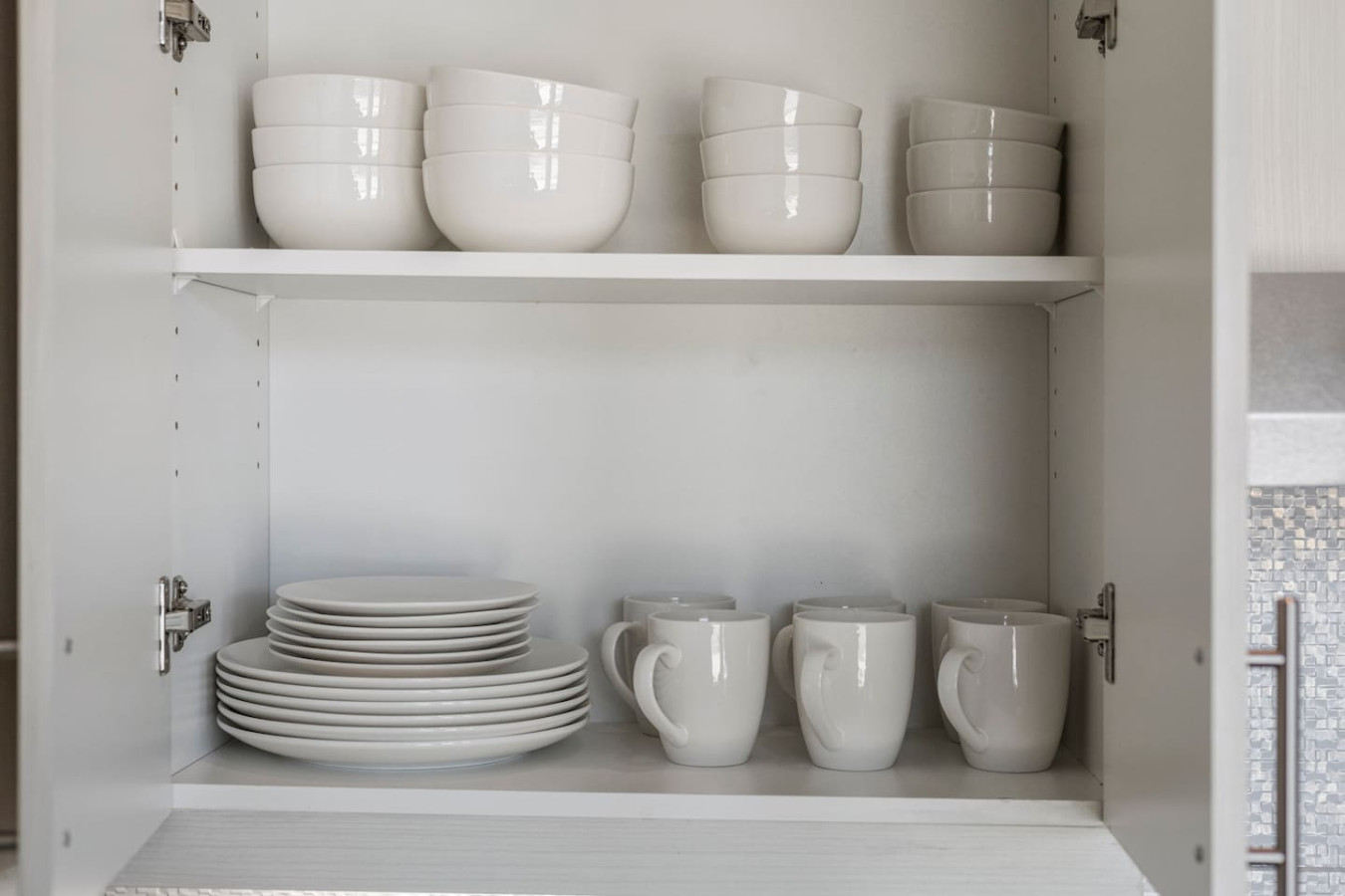 Kitchen cabinets stocked with cooking wares, glassware and silverwares, ideal for mixing up your favorite meals and drinks during your stay.