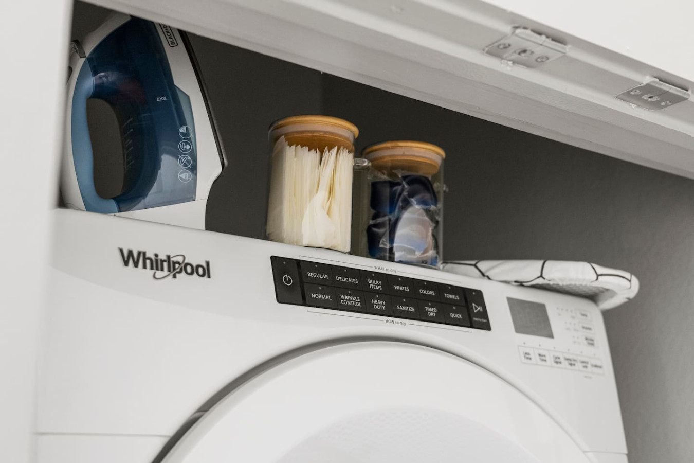 As you step into the laundry room, the modern appliances and ample storage space make it easy to keep things tidy.