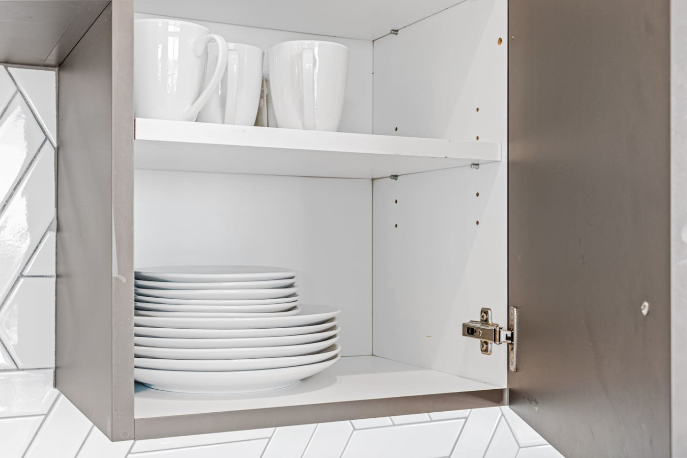 Kitchen cabinets stocked with cooking wares, glassware and silverwares, ideal for mixing up your favorite meals and drinks during your stay.