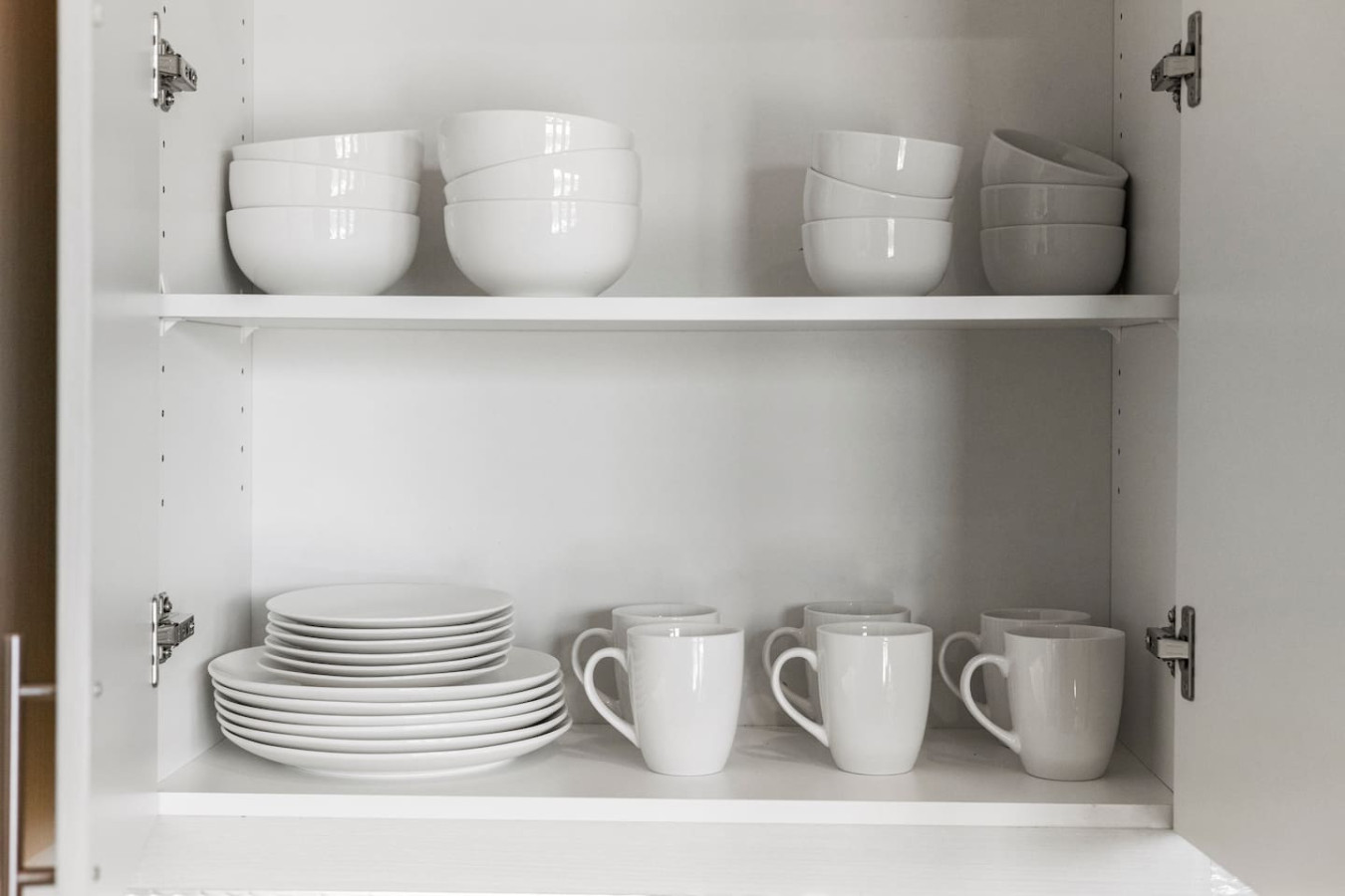 Kitchen cabinets stocked with cooking wares, glassware and silverwares, ideal for mixing up your favorite meals and drinks during your stay.