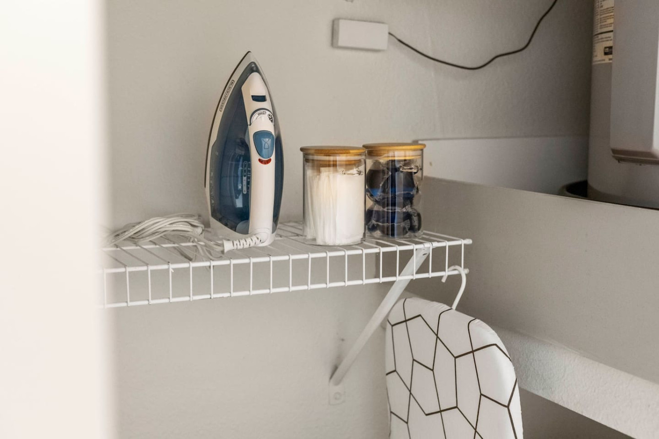 As you step into the laundry room, the modern appliances and ample storage space make it easy to keep things tidy.
