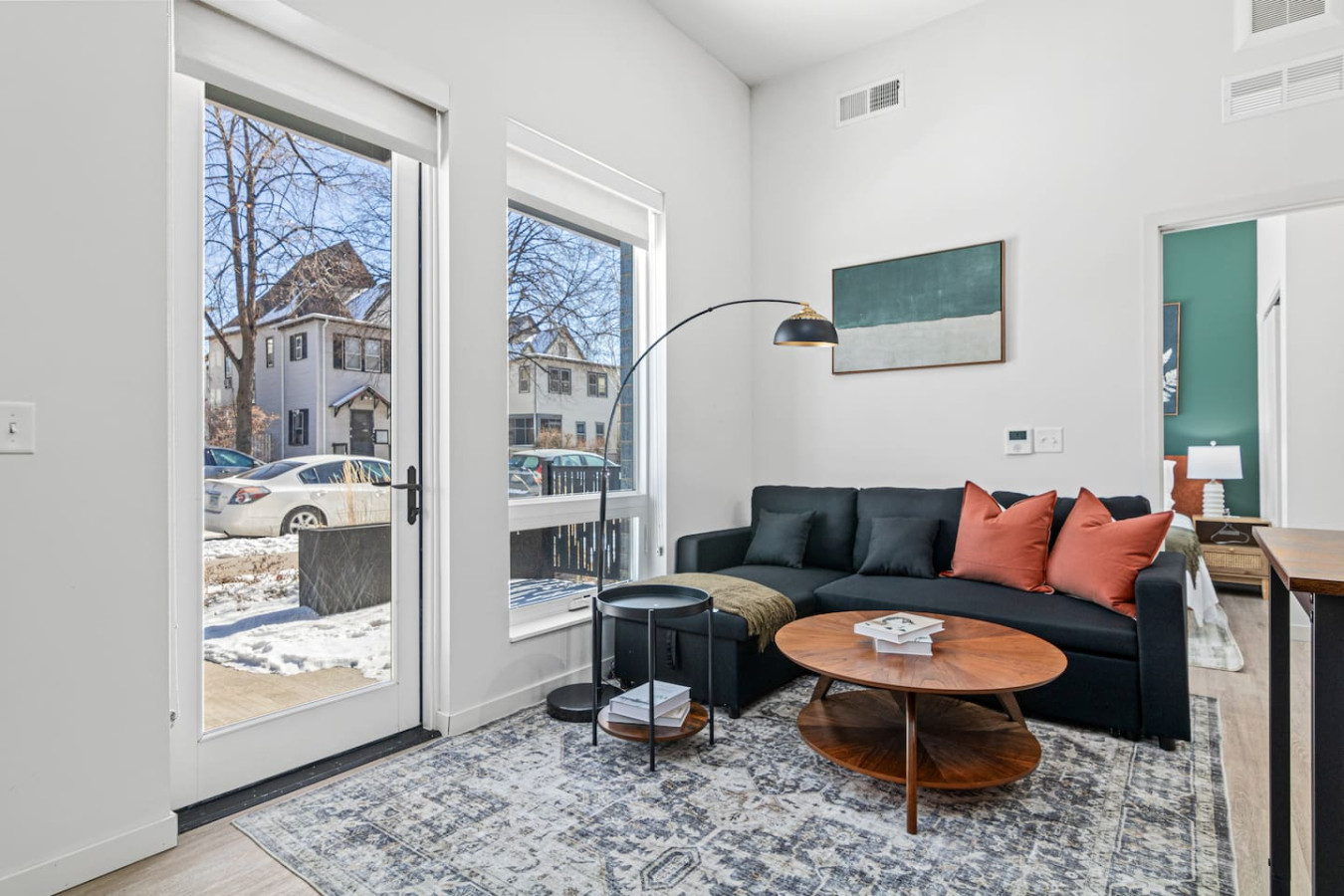 The living room is filled with natural light, creating a bright and welcoming space that invites relaxation.