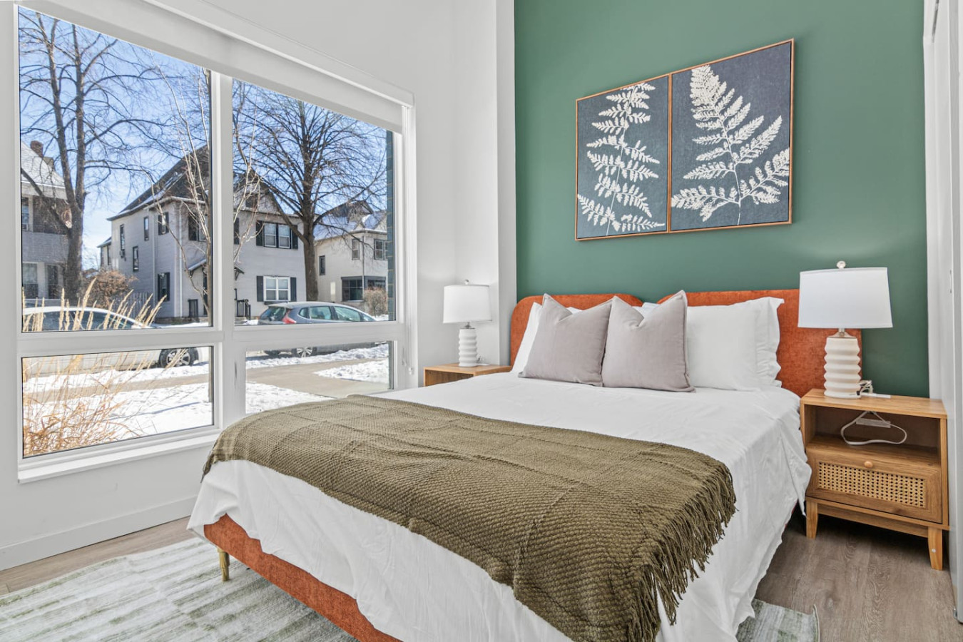 You feel enveloped in comfort as you relax on the queen bed, surrounded by a room designed for tranquility.