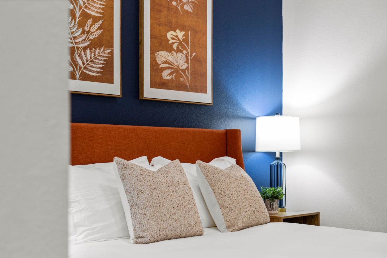 You feel enveloped in comfort as you relax on the queen bed, surrounded by a room designed for tranquility.