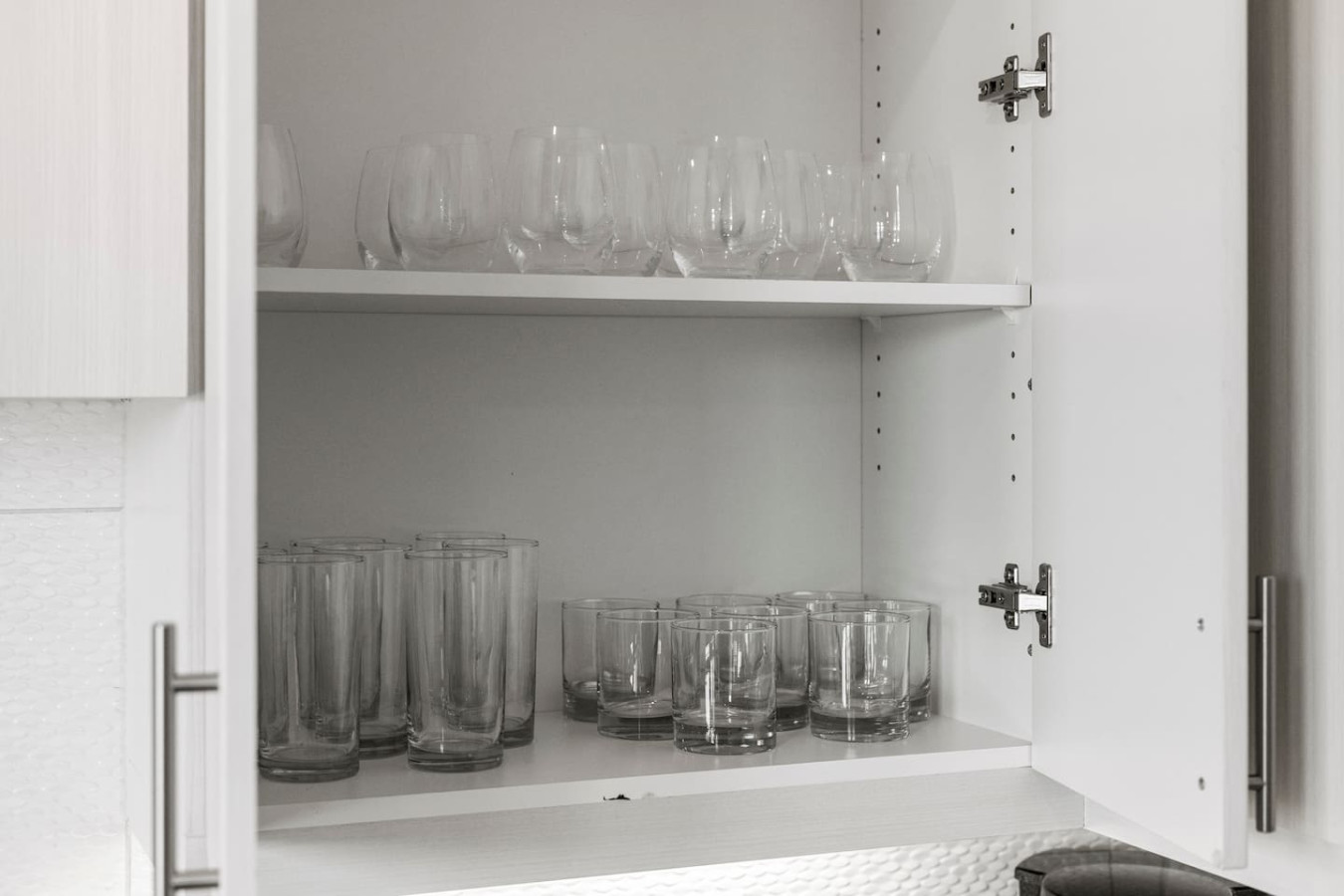 Kitchen cabinets stocked with cooking wares, glassware and silverwares, ideal for mixing up your favorite meals and drinks during your stay.