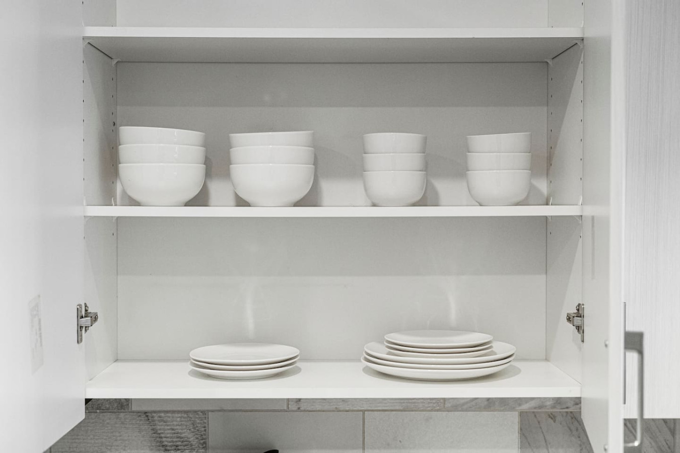 Kitchen cabinets stocked with cooking wares, glassware and silverwares, ideal for mixing up your favorite meals and drinks during your stay.