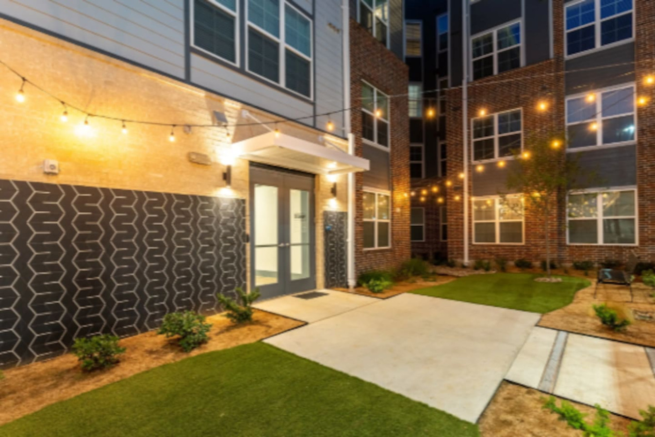 As you approach the house, the inviting entrance and beautiful exterior make you eager to explore what’s inside.