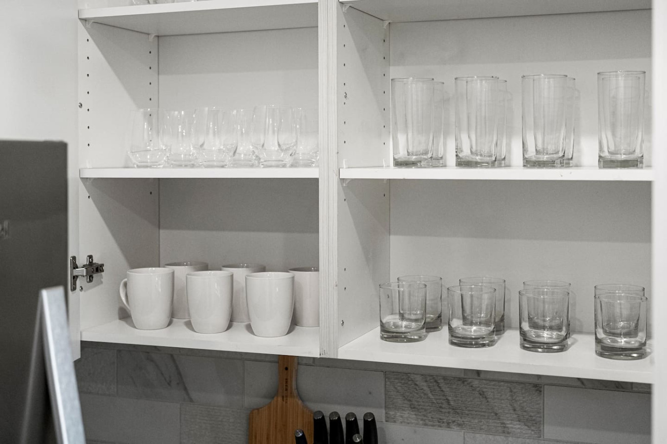 Kitchen cabinets stocked with cooking wares, glassware and silverwares, ideal for mixing up your favorite meals and drinks during your stay.