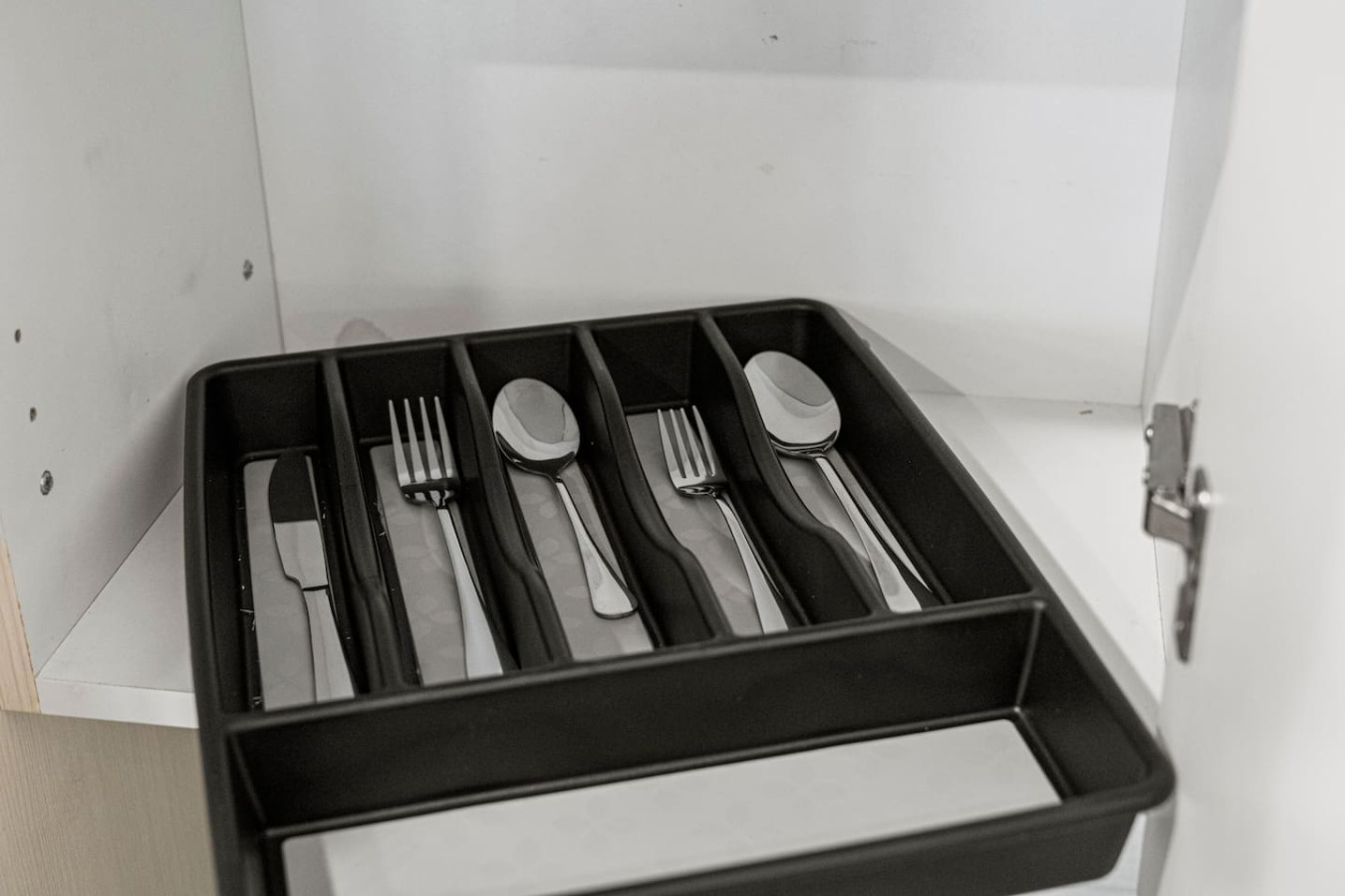 Kitchen cabinets stocked with cooking wares, glassware and silverwares, ideal for mixing up your favorite meals and drinks during your stay.