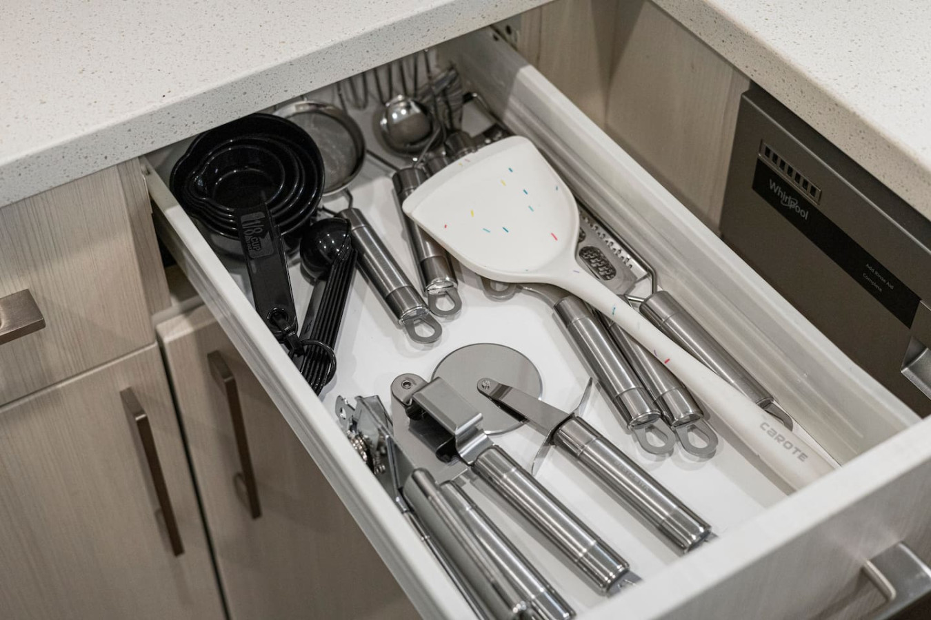 Kitchen cabinets stocked with cooking wares, glassware and silverwares, ideal for mixing up your favorite meals and drinks during your stay.