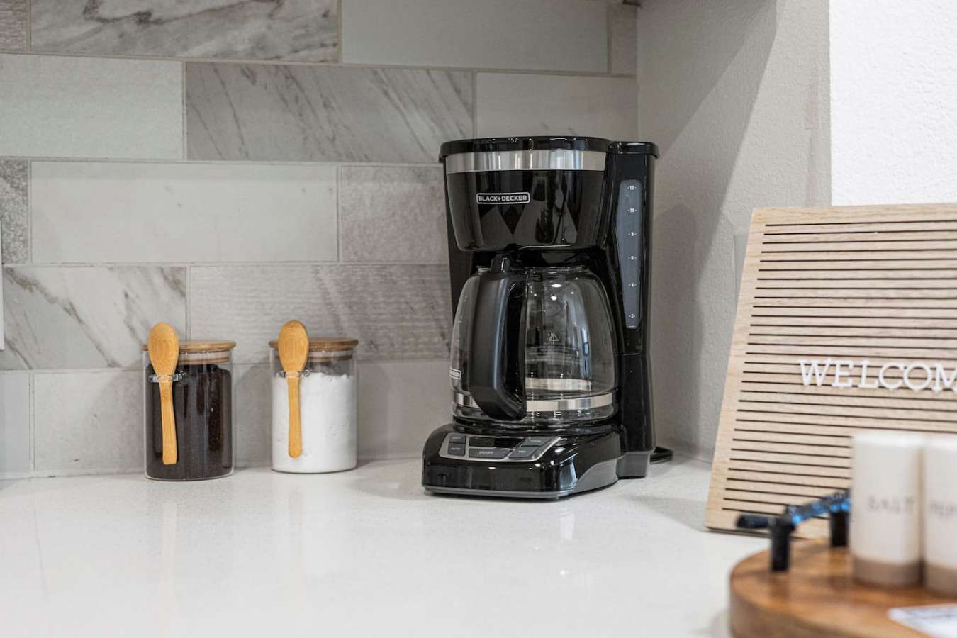 As you open the kitchen, you discover an assortment of coffee pods, and sugar, ensuring you have everything you need for a perfect morning or afternoon pick-me-up.