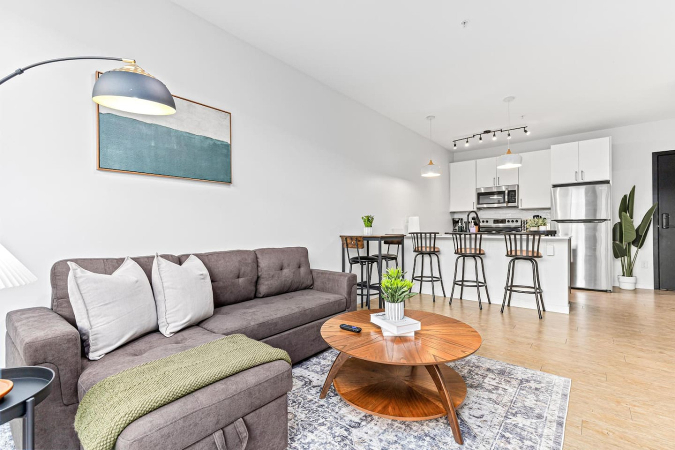 Spacious open-concept living and dining area featuring a vibrant sofa, modern furnishings, and a stylish entertainment setup—ideal for gatherings and relaxation.