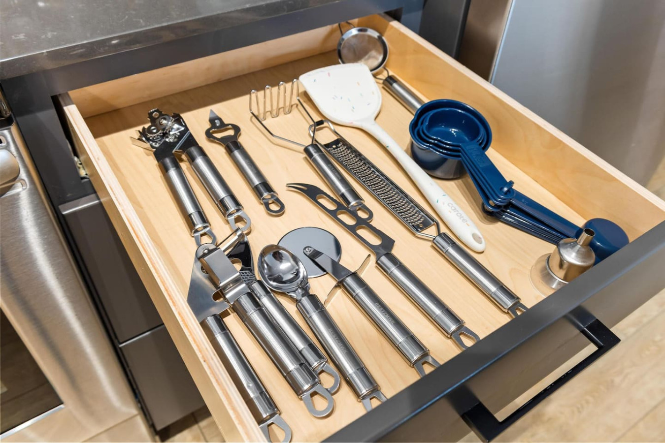 Kitchen utensils with scissors, measuring cups, grater, wine opener, can opener