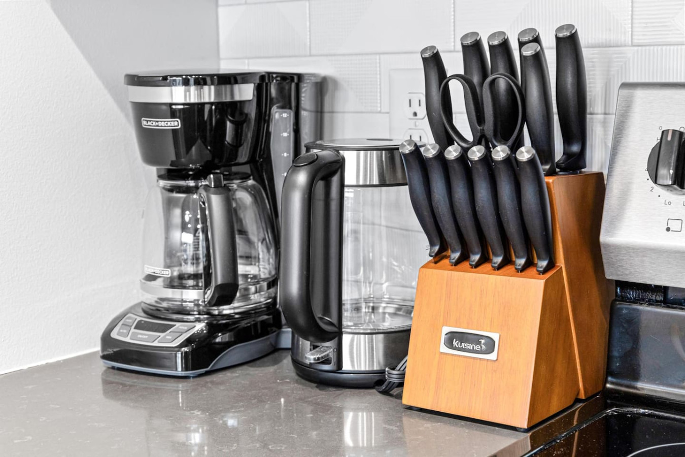 Kitchen cabinets stocked with cooking wares, glassware and silverwares, ideal for mixing up your favorite meals and drinks during your stay.