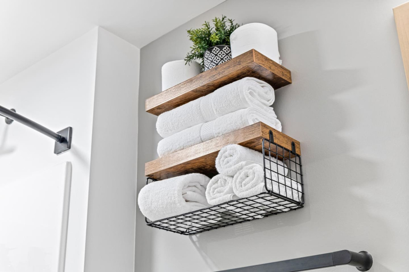 Immaculate bathroom featuring a spacious shower, fresh towels, and complimentary toiletries for a spa-like experience.