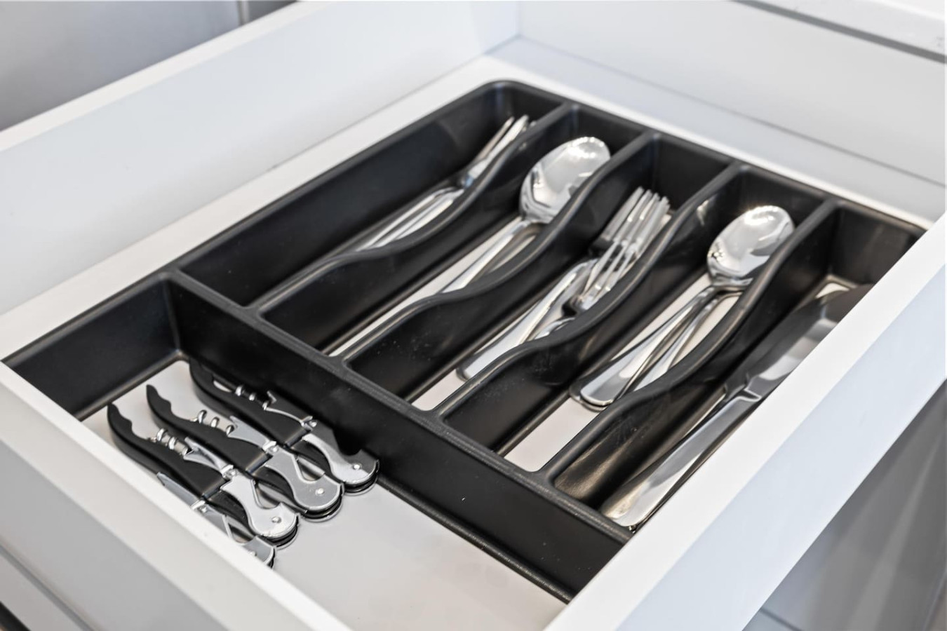Kitchen cabinets stocked with cooking wares, glassware and silverwares, ideal for mixing up your favorite meals and drinks during your stay.