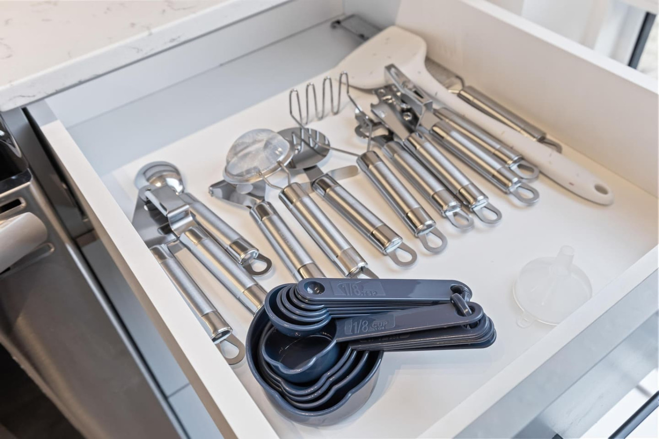 Kitchen utensils with scissors, measuring cups, grater, wine opener, can opener